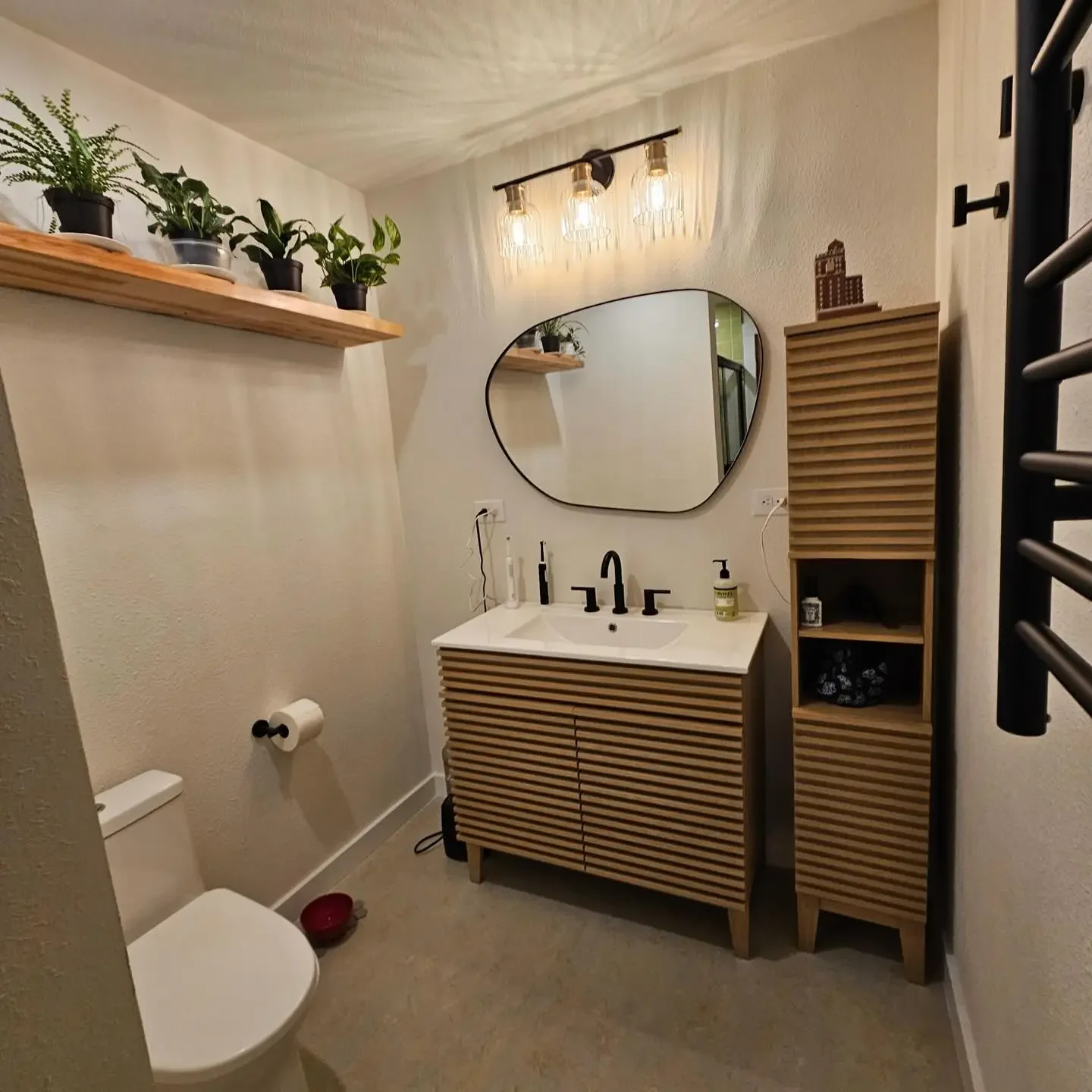 Finished bathroom remodel by Jepsen Construction with a modern vanity and storage cabinet