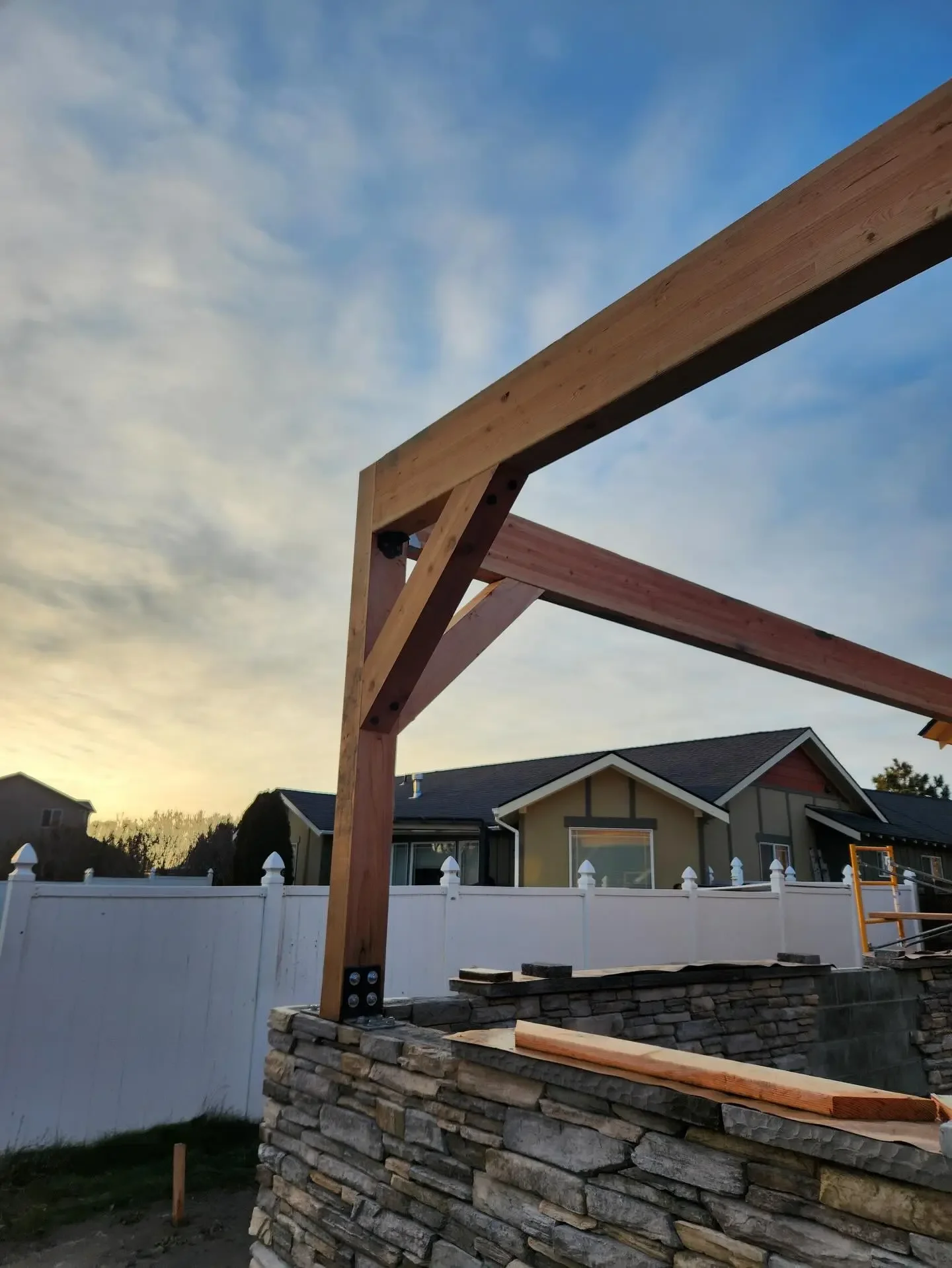 Timber frame structure built over a stone patio by Jepsen Construction