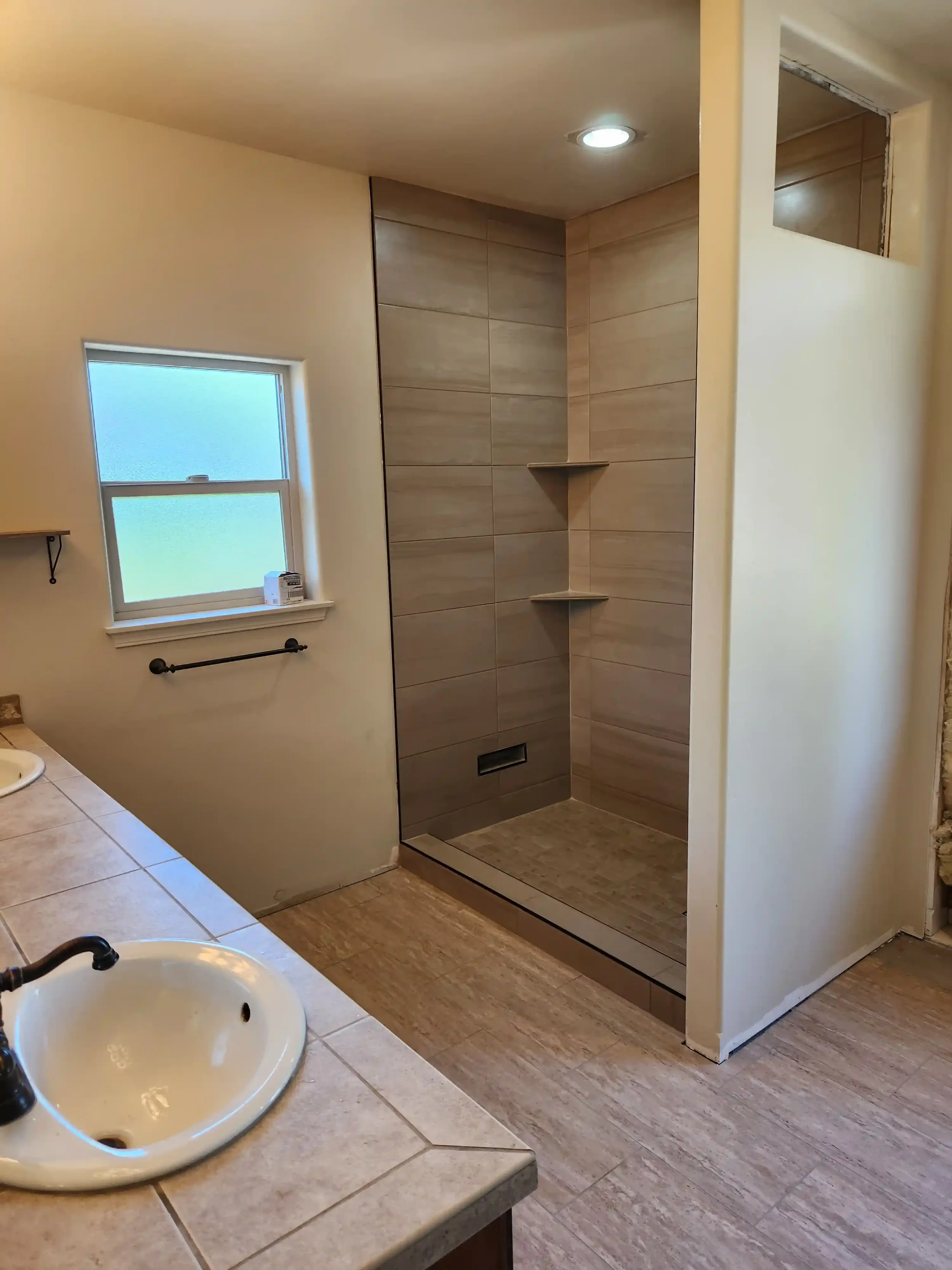 Bathroom remodel featuring a tiled walk-in shower by Jepsen Construction