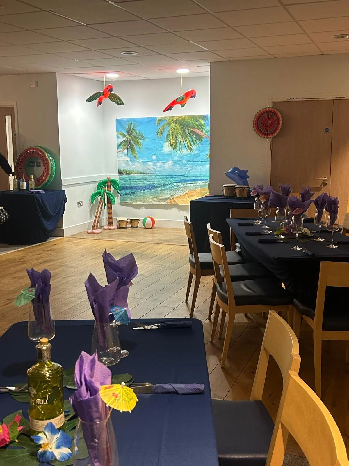 Two beige ceramic vases, one with dried flowers and seed pods, on a light surface against a neutral background.
