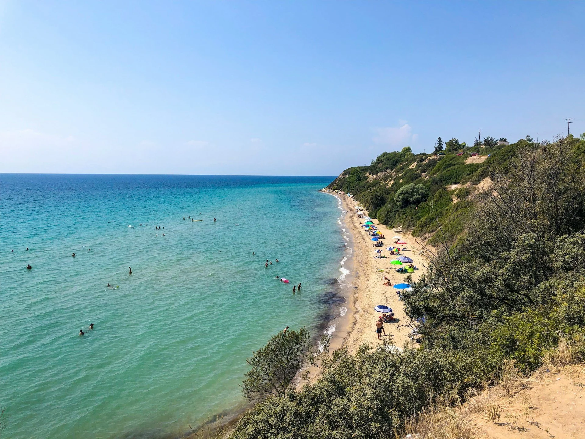 sandy beach in Kallikrateia Greece with calm sea and coastal landscape. Sandy beach near Kallikrateia, Greece with calm sea and natural coastline