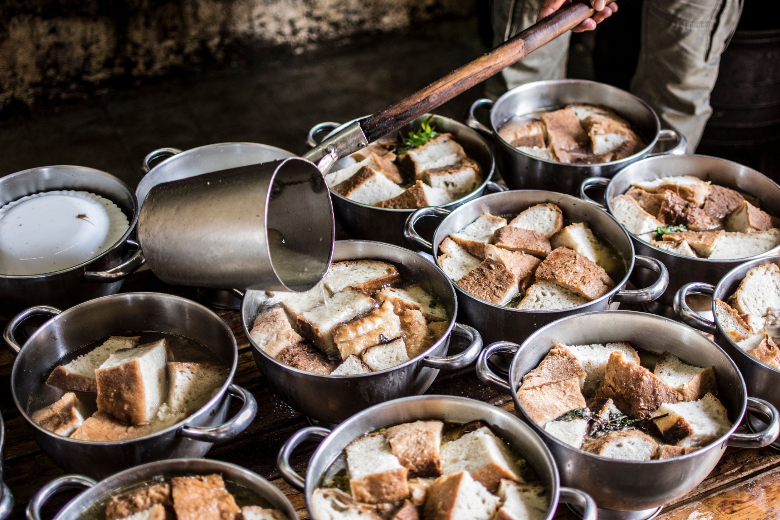 A rustic kitchen scene with pots of traditional bread soup being prepared in the Azores, Portugal