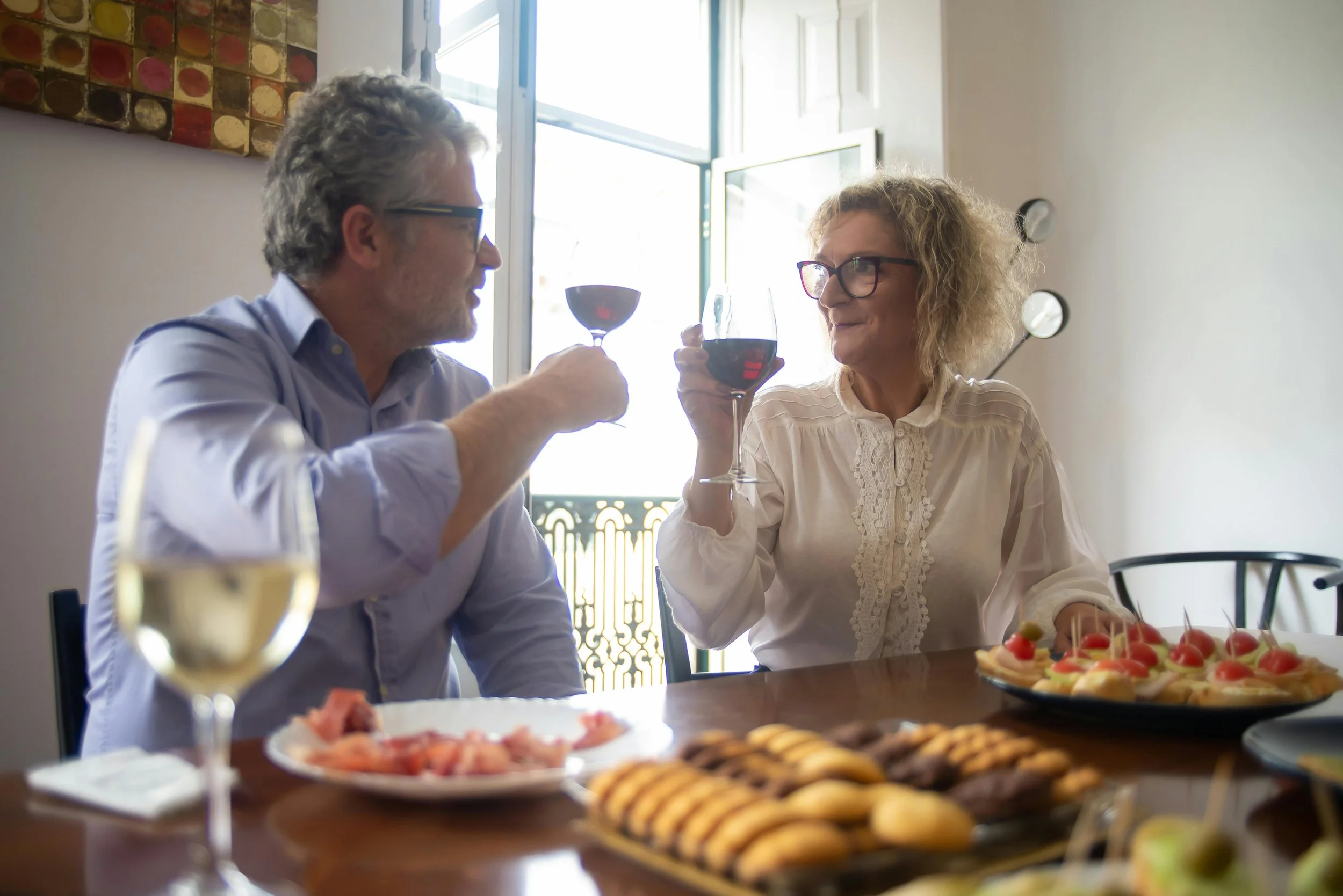 Couple in Portugal drinking red wine and eating appetizers in Portugal