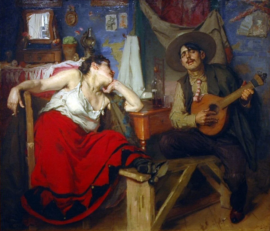 A woman sitting on a chair with a red skirt and white blouse, resting her face on her hand, appears to be singing or talking. A man sitting opposite her wearing a large sombrero hat, playing a guitar and smiling, in a cozy, rustic room with colorful walls and old-style furnishings.