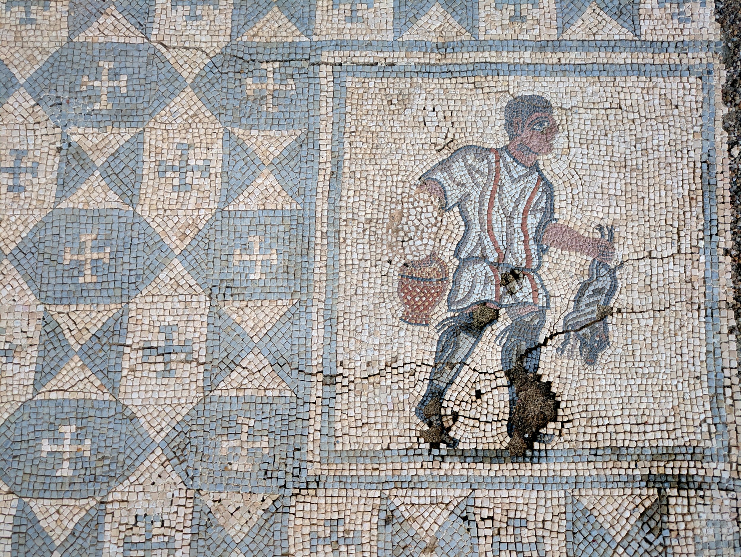 Mosaic design featuring the figure of a hunter or peasant. This figurative panel is integrated into a geometric pavement in the Casa dos Repuxos (or Casa das Fontes)