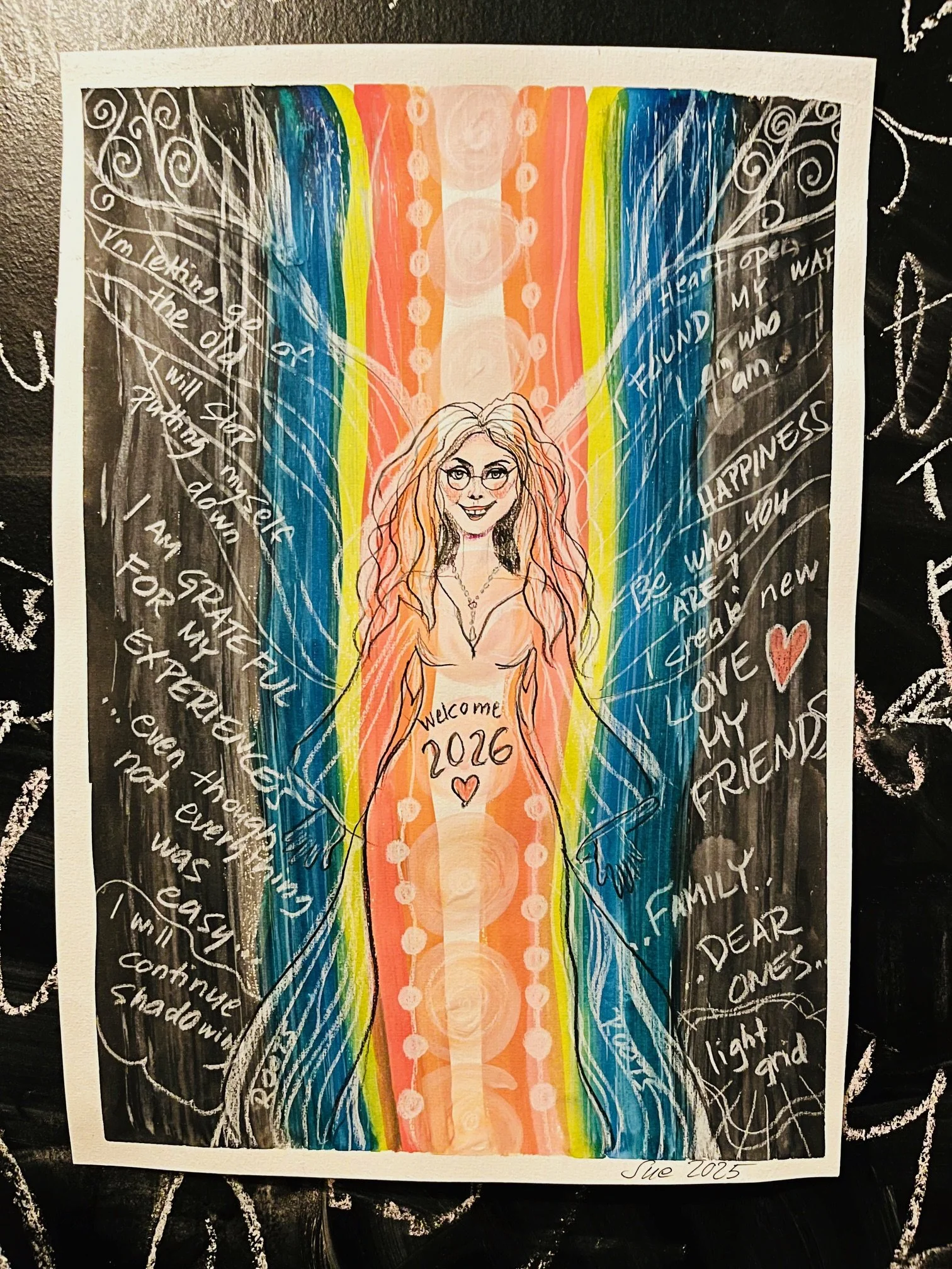An illustrated colorful drawing of a woman with long, wavy hair and glasses, standing in front of a vibrant rainbow background. She has a tattoo on her stomach reading 'Welcome 2026' with a heart. Surrounding her are handwritten positive messages and