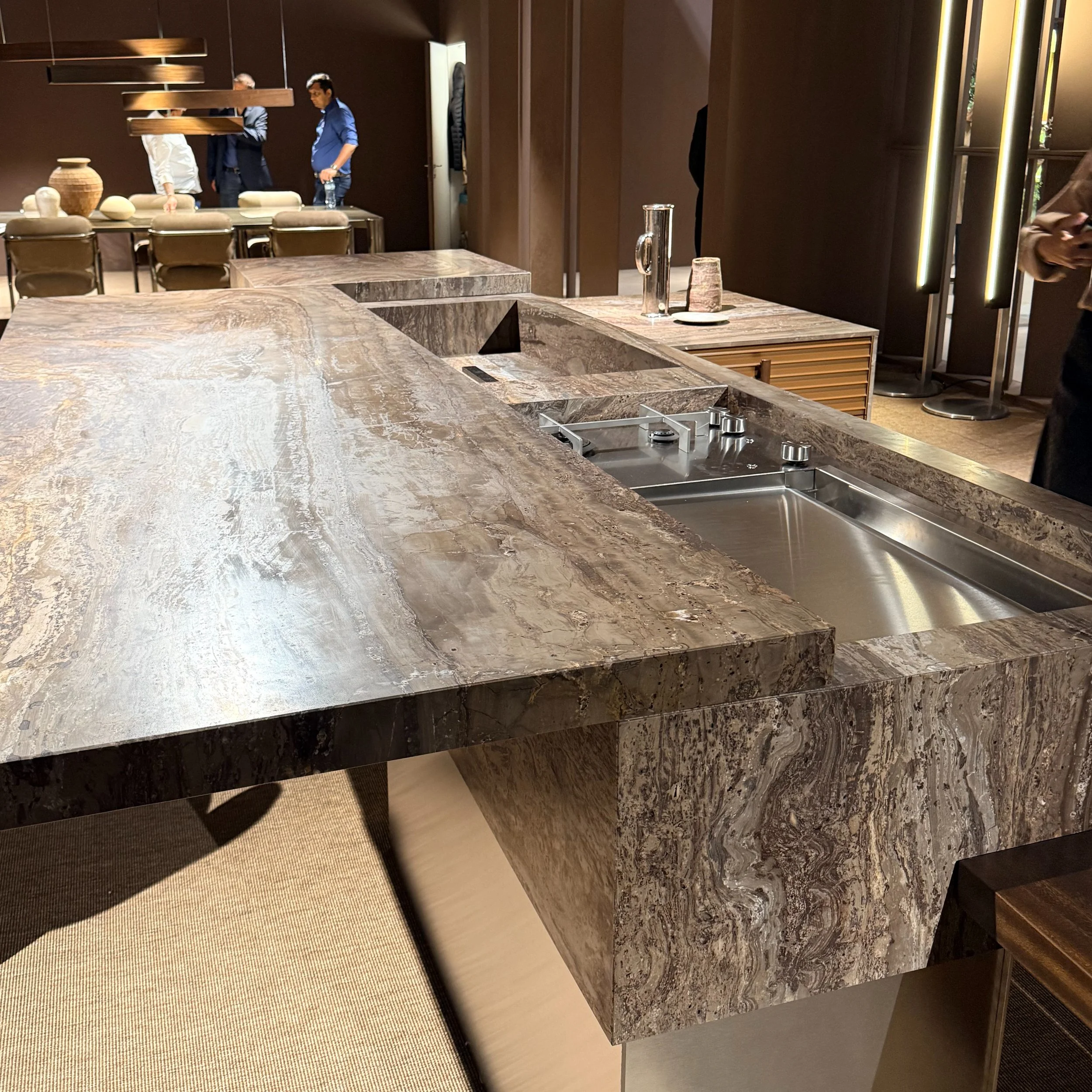A closer look at the kitchens redefining luxury through craftsmanship, modularity, and materiality. From sculptural stone islands and integrated metal detailing to seamless walnut joinery and architectural forms, these designs prove the kitchen has b