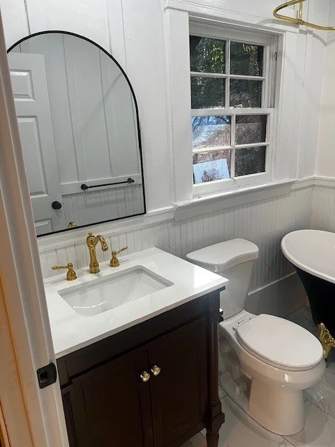 For this small but mighty bathroom remodel, we combined classic 1800s elegance with modern functionality. The walnut vanity, black clawfoot tub, marble tile flooring, and polished brass fixtures all came together to create a truly timeless space that