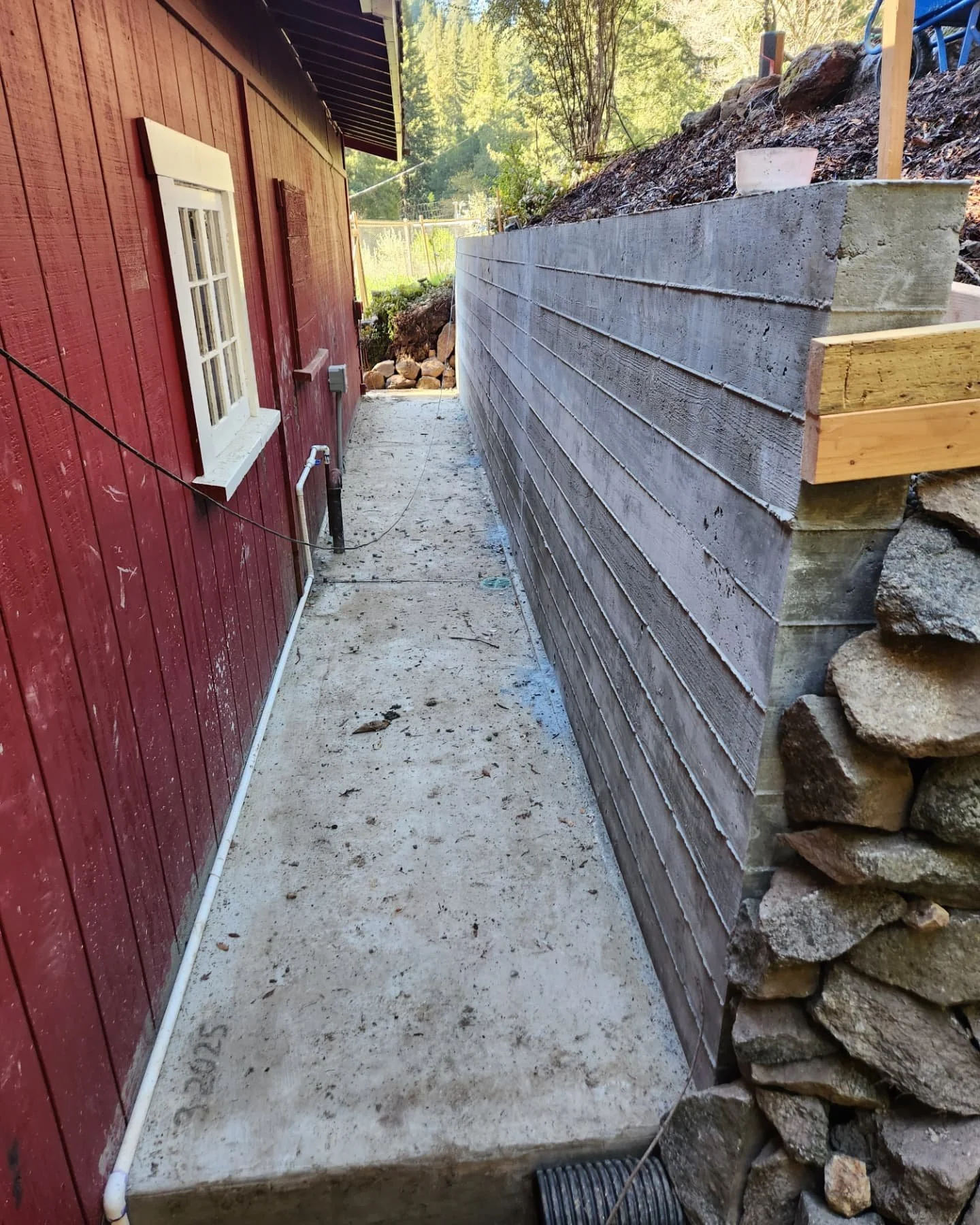 Lots of concrete! Solid poured concrete retaining wall sitting on a 1ft thick footing. #thataintgoingnowhere