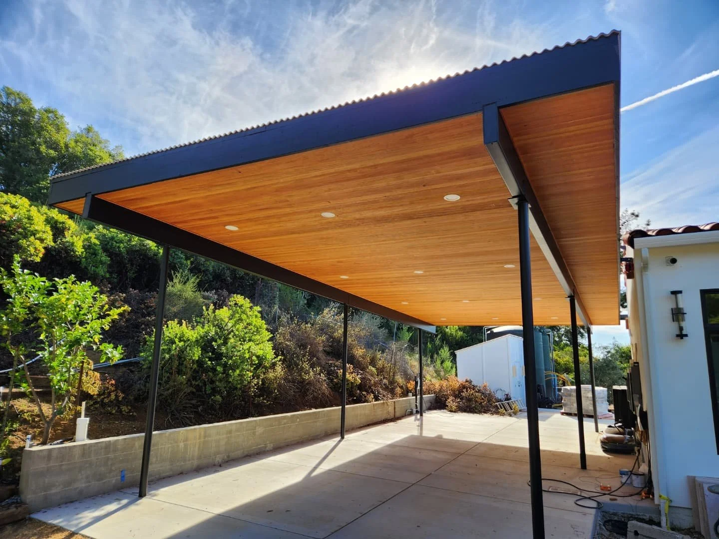 A structural steel carport we completed last year. 20x50 steel frame over a concrete pad, with metal roofing and t&amp;g ceiling.
