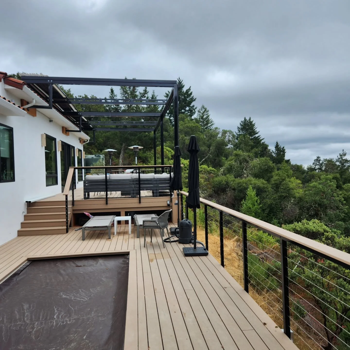Custom metal railing and pergola for a house with a view! The pergola has automatic shades that extend to block the sun on hot days and keep the decking cool. 

#railing #metal #mountains #pergola