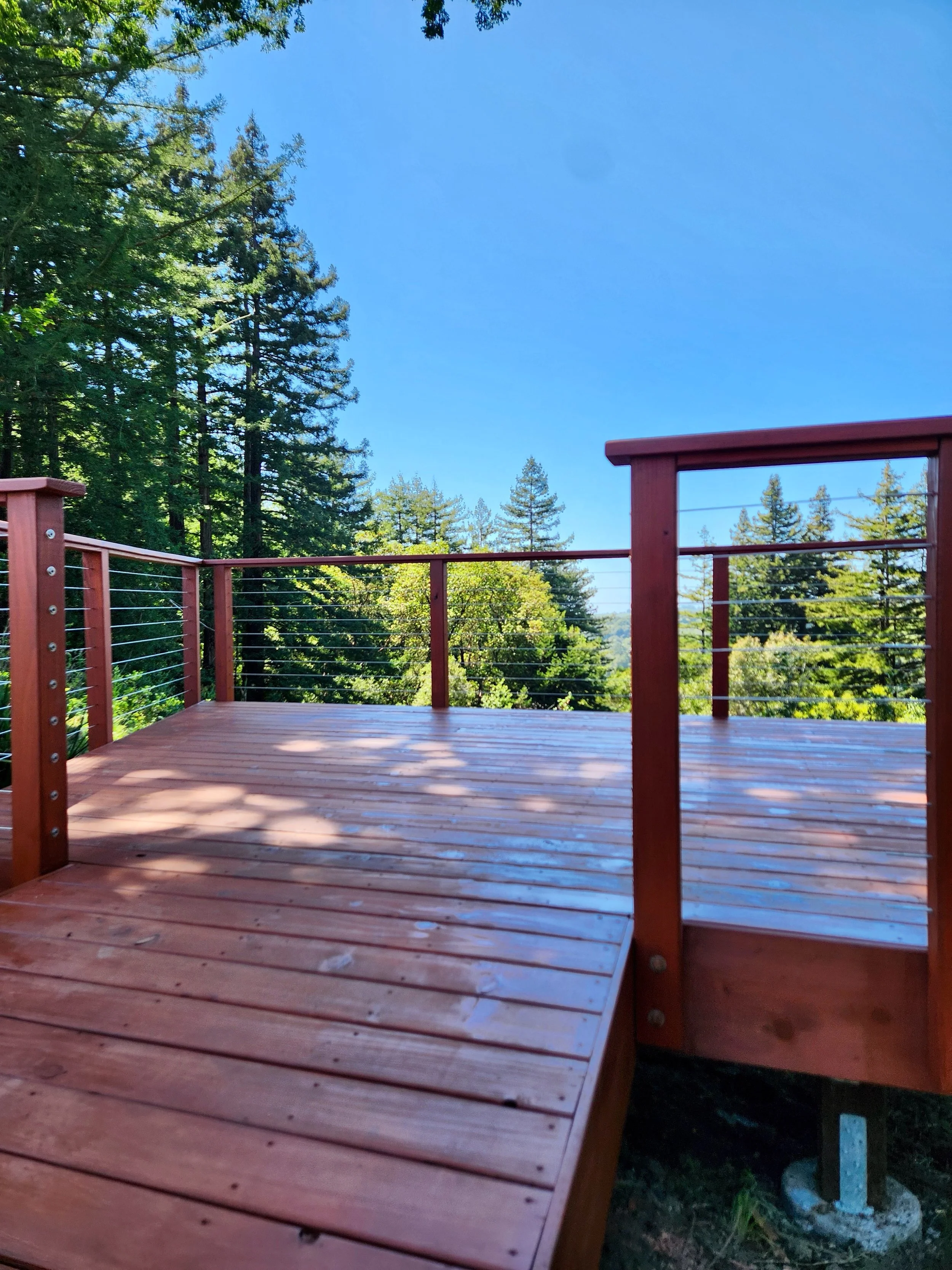 A new redwood deck built with locally milled, sustainably sourced wood - warm, natural, and made to belong in its surroundings. Looks beautiful and performs great outdoors.