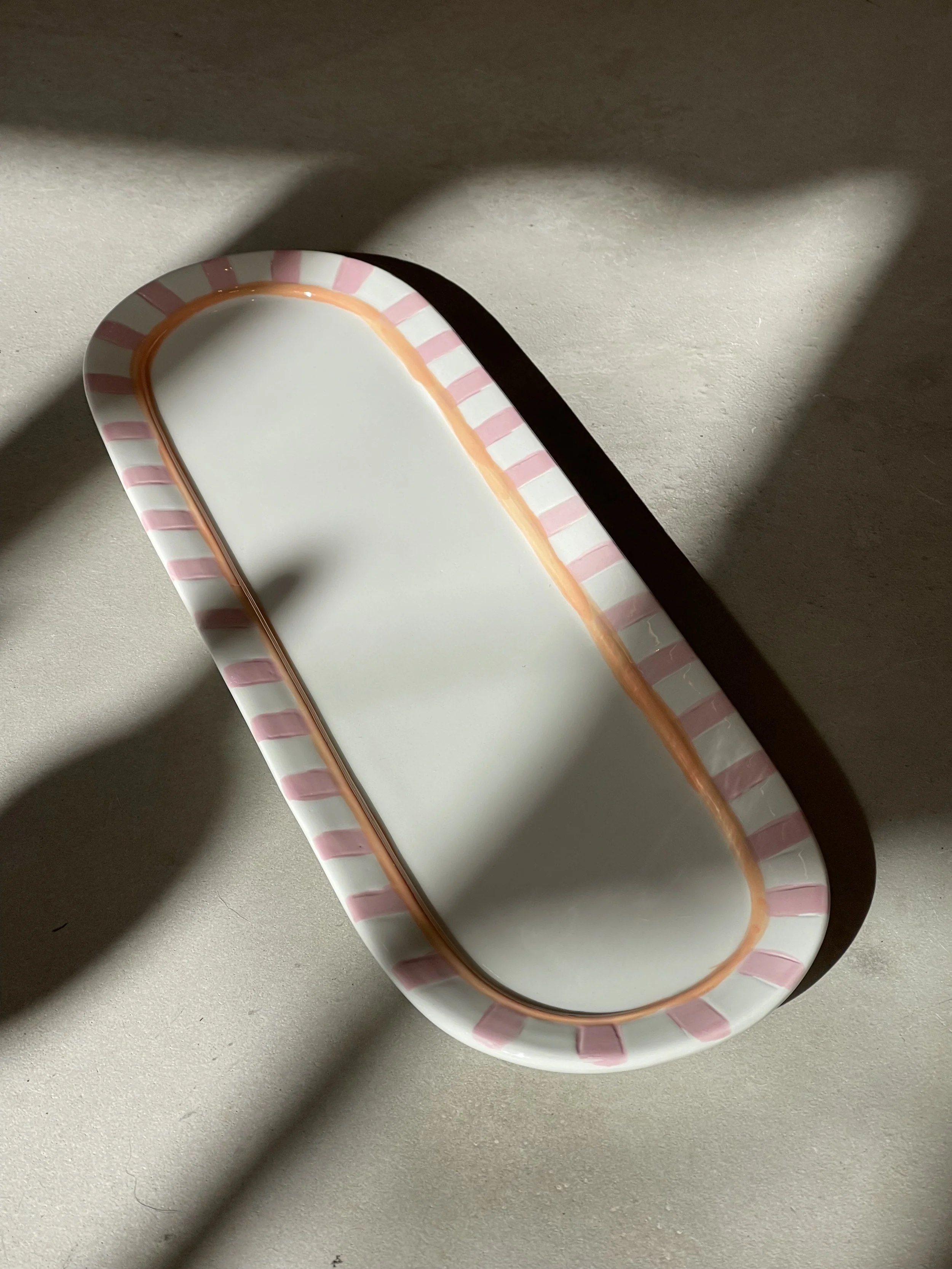 Pink and orange striped ceramic serving dish
