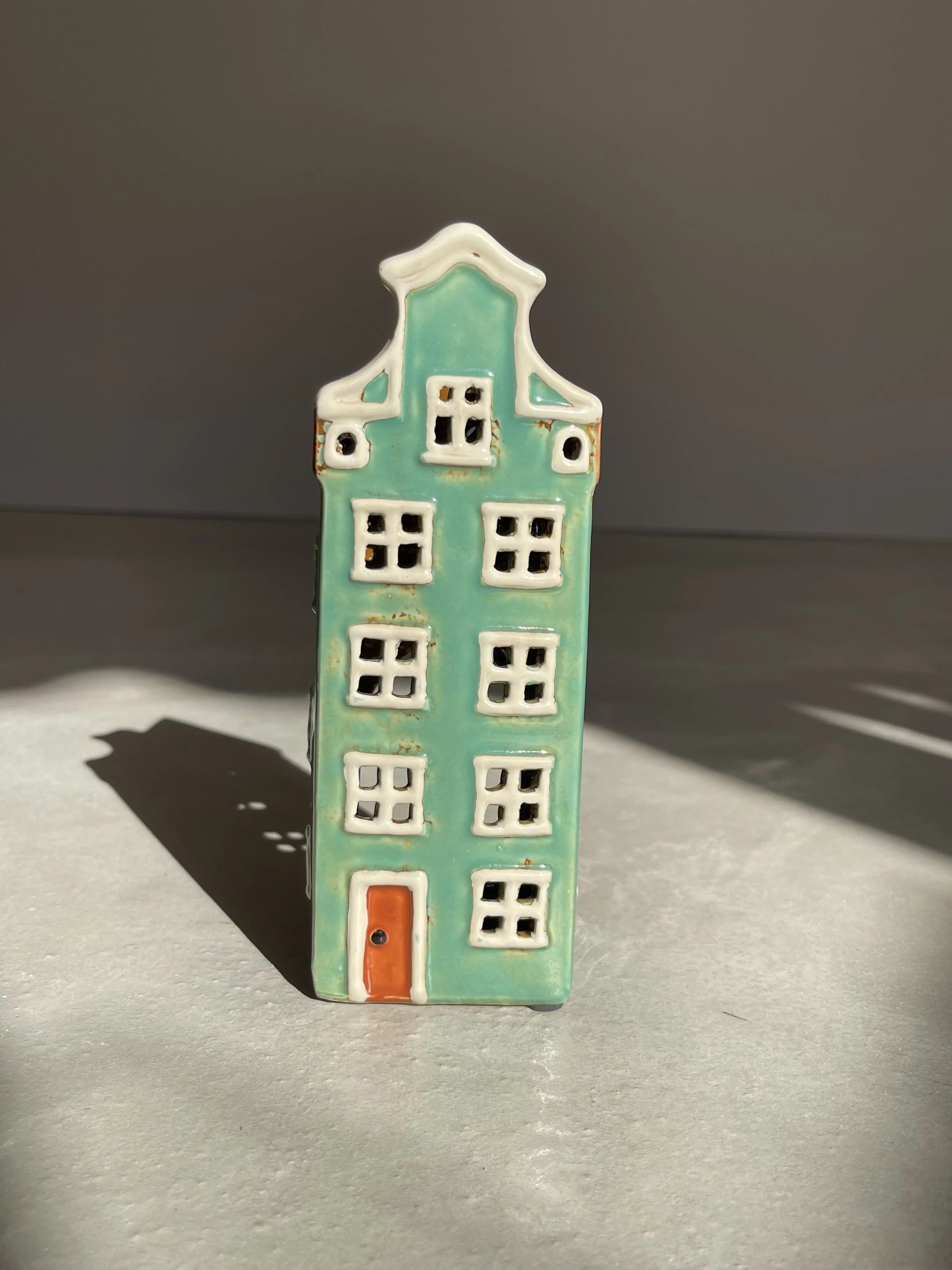 Tall green ceramic house