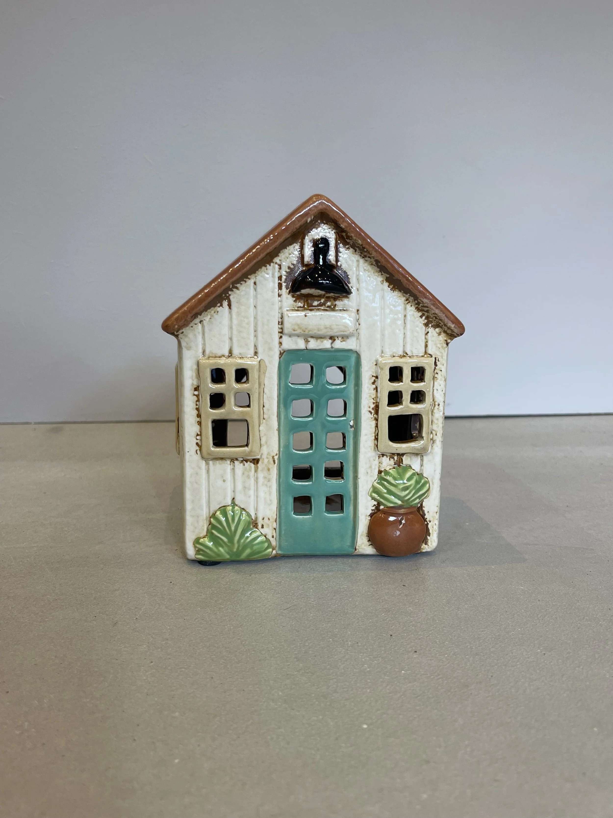 Cream rustic ceramic house blue door