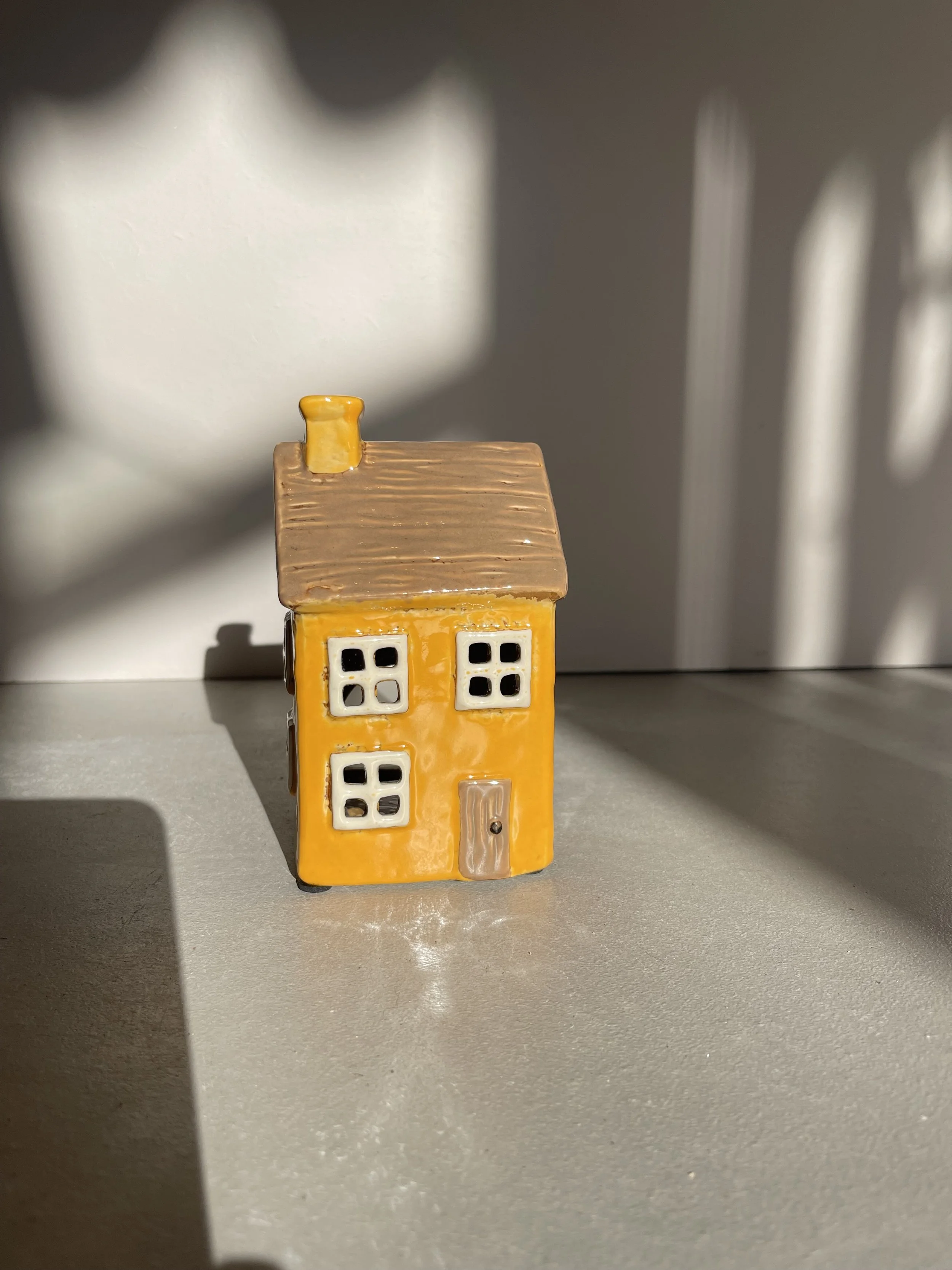 Yellow ceramic house tea light holder