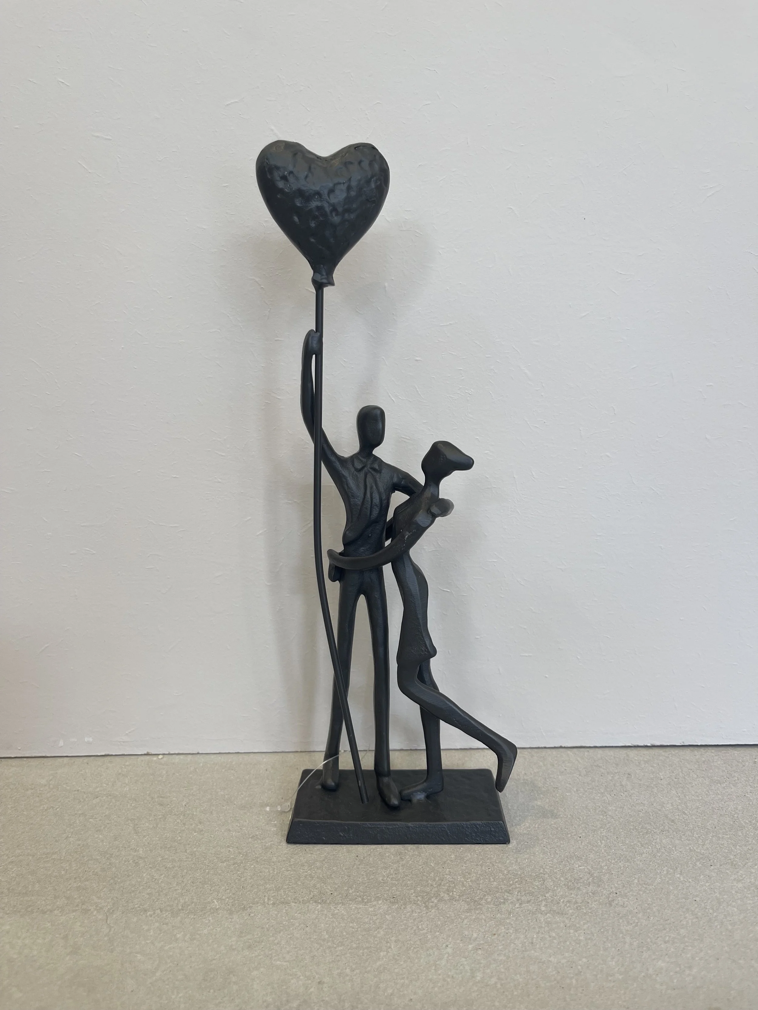 Metal couple with heart balloon