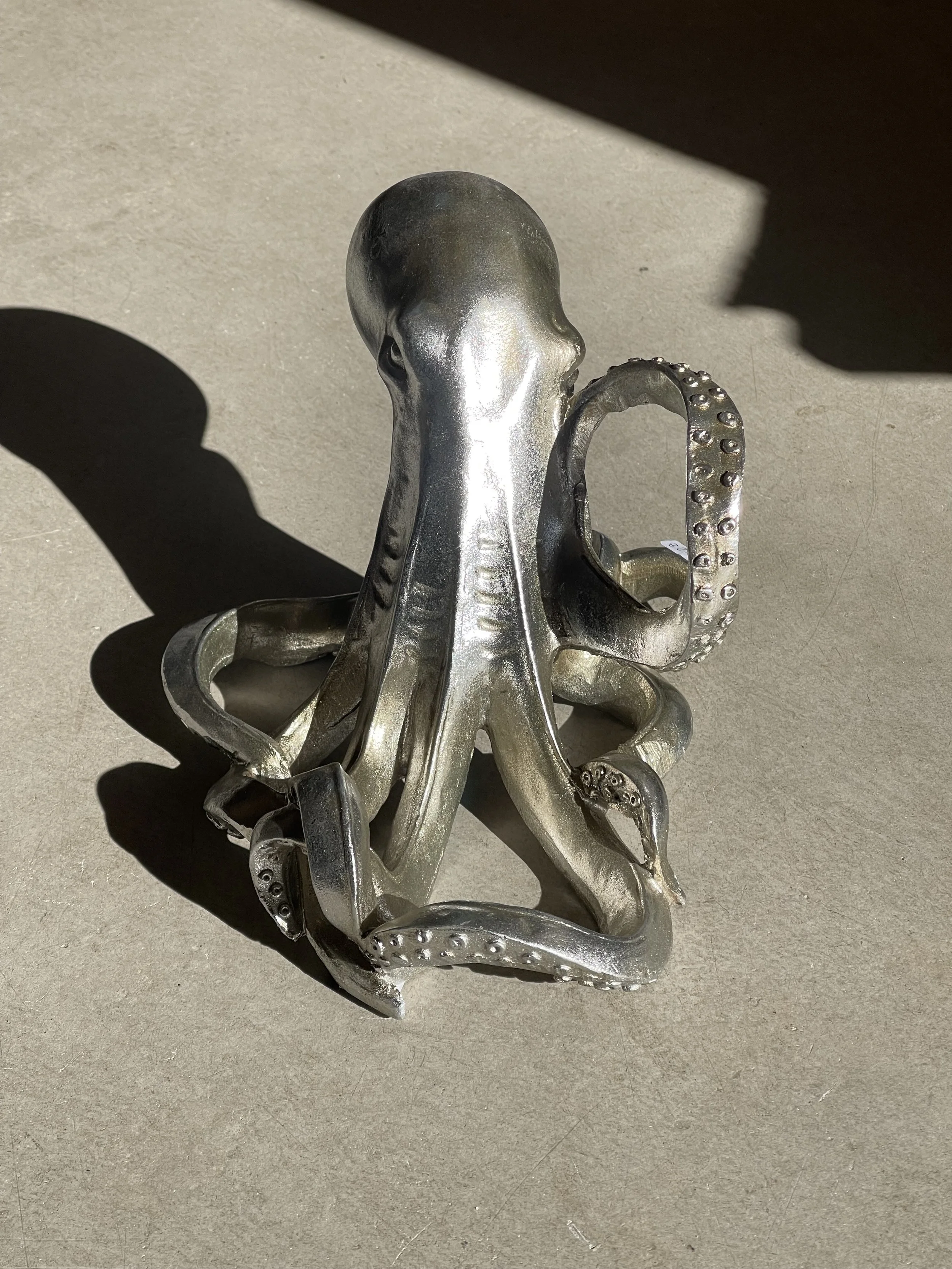Silver octopus wine bottle holder perfect for coastal decor and quirky homeware. Avilable in Ruby's Designs giftshop in Looe, Cornwall.