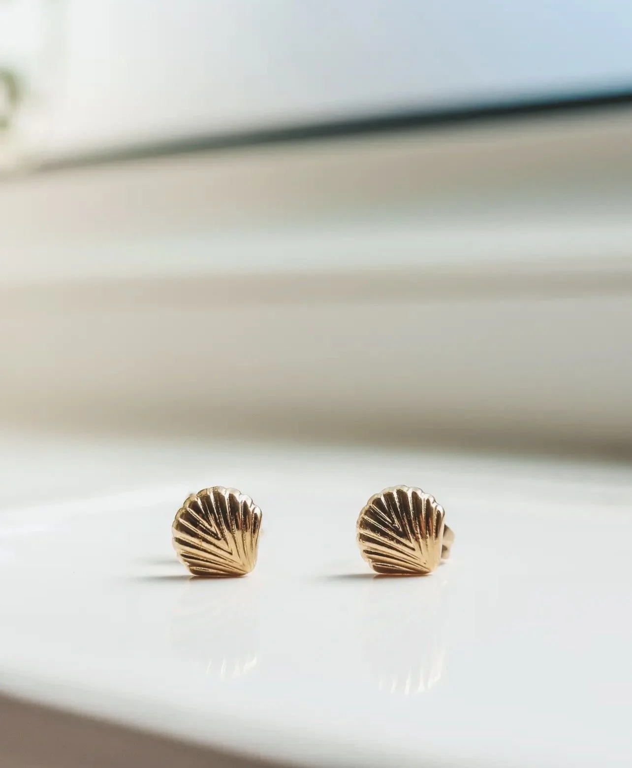 Gold shell stud earrings