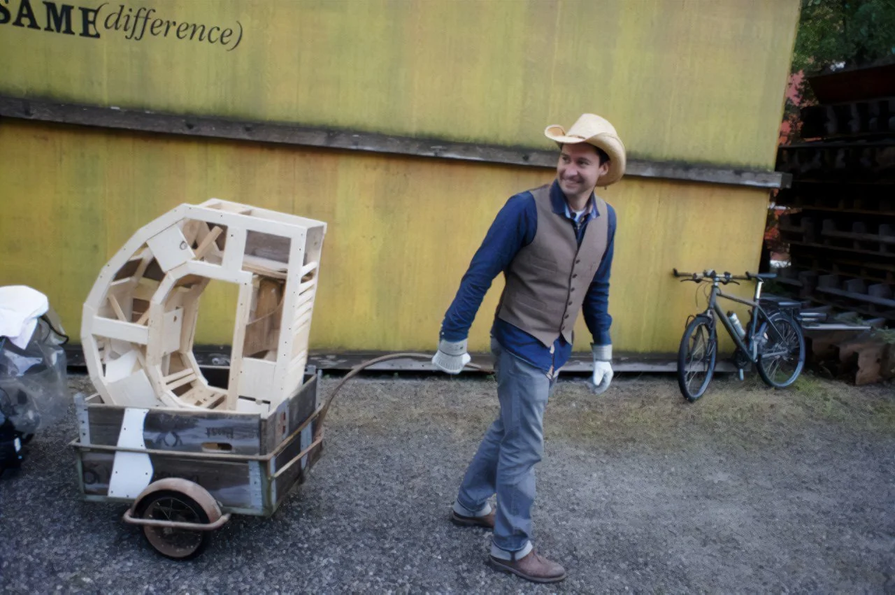 Art Title - Hotdog, Merlin Zuni, photo of Merlin Zuni setting up his transformative sculptural art installation consisting of large 3d letters