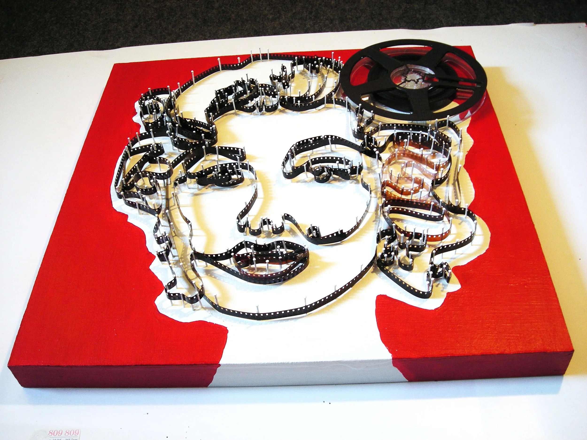 Art portrait of Marilyn Monroe recreating her likeness with 8mm film.