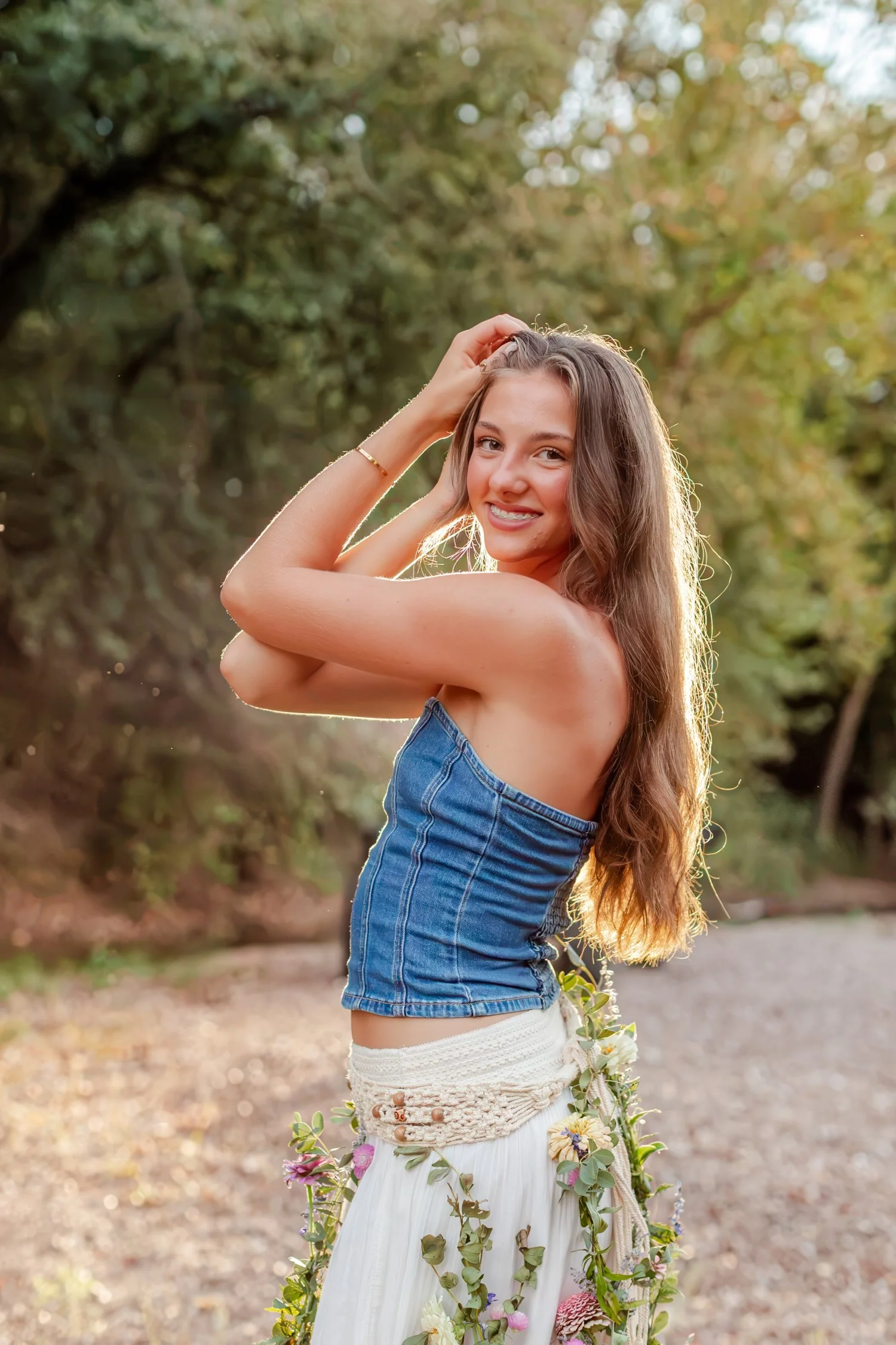 Eisley looking over her shoulder in a denim top, senior pictures near Bolivar, MO