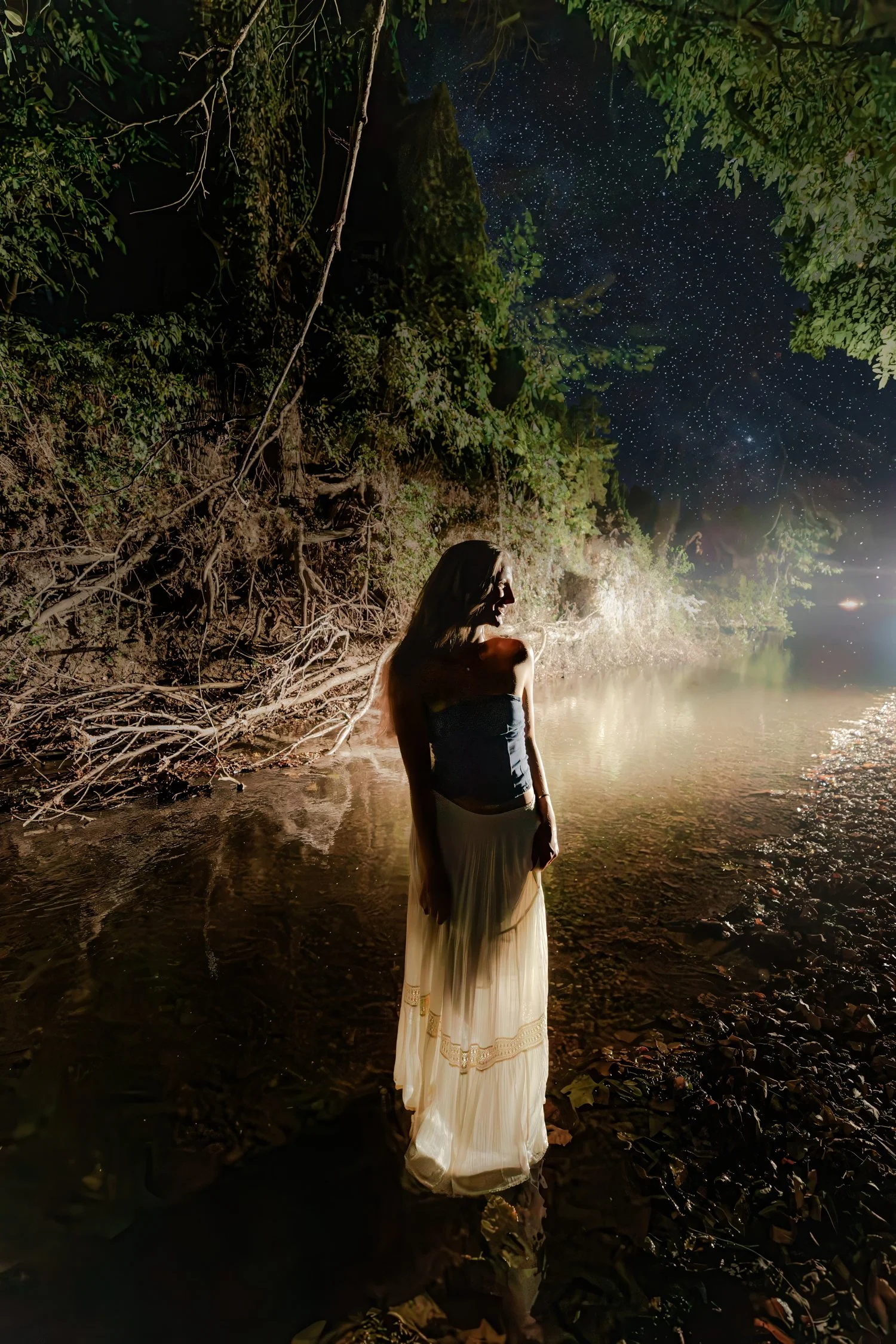 Eisley standing in the river with light haze after dark, senior pictures near Bolivar, MO