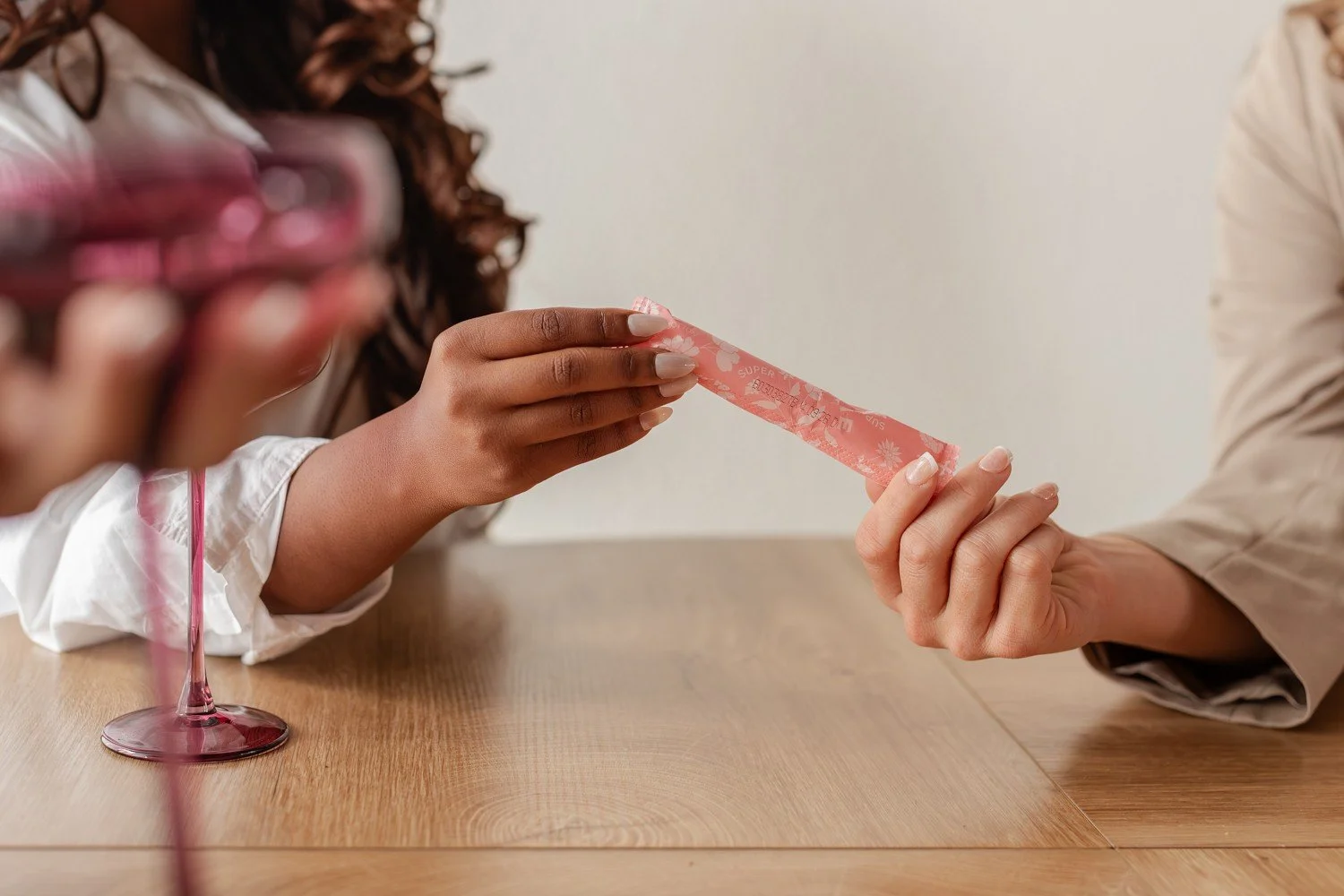 Close view of hands holding a wrapped Pixie Cup tampon