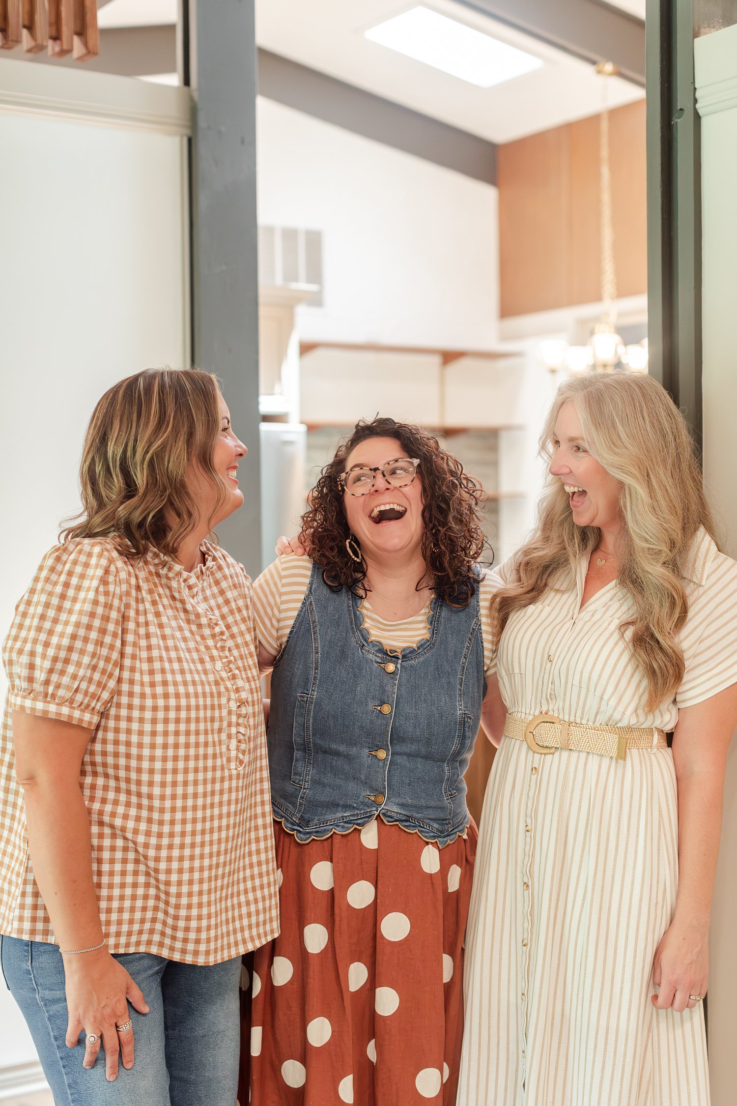 Three Stellar Real Estate Co. agents laughing together in a hallway, team photos in Bolivar, MO