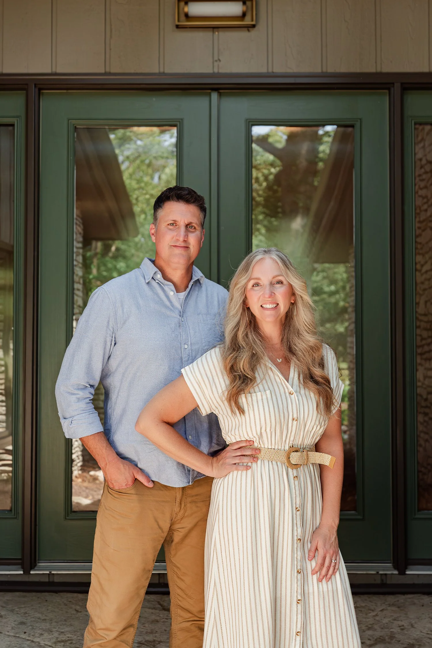 Two real estate agents on the front walk at a green double door, full length team photo in Bolivar, MO
