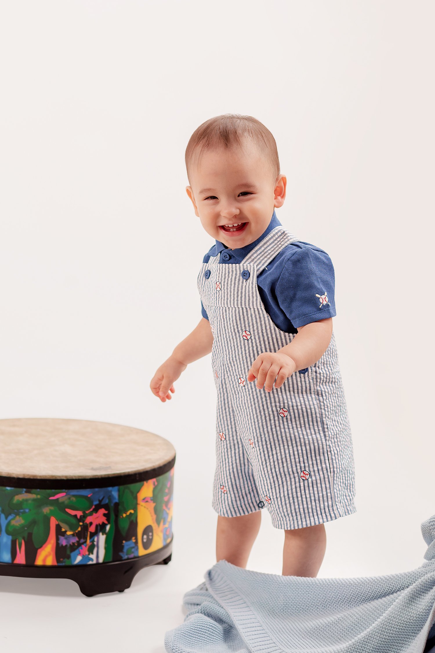 Winston smiling as he stands beside his drum