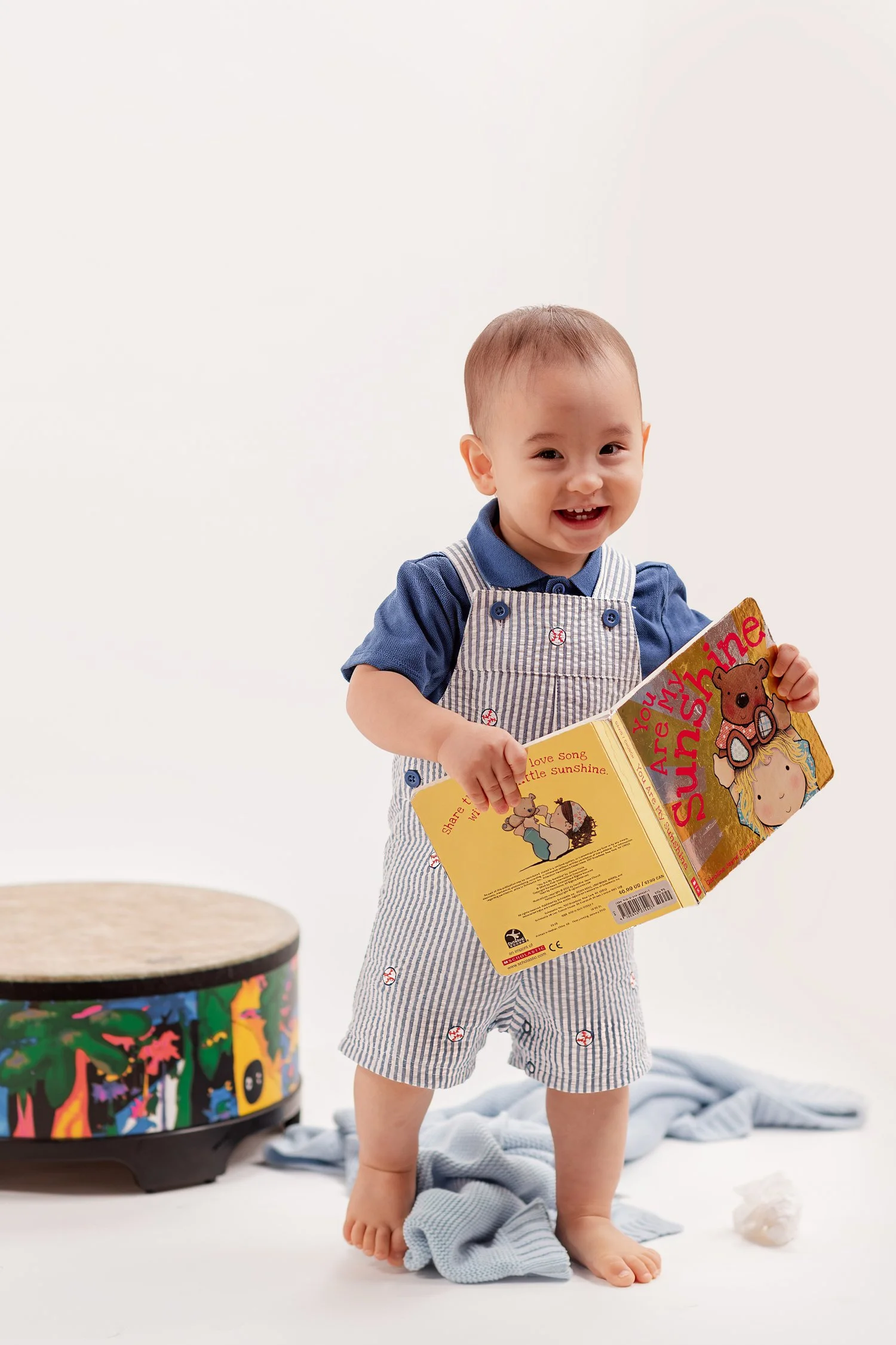 Winston smiling while holding an open board book