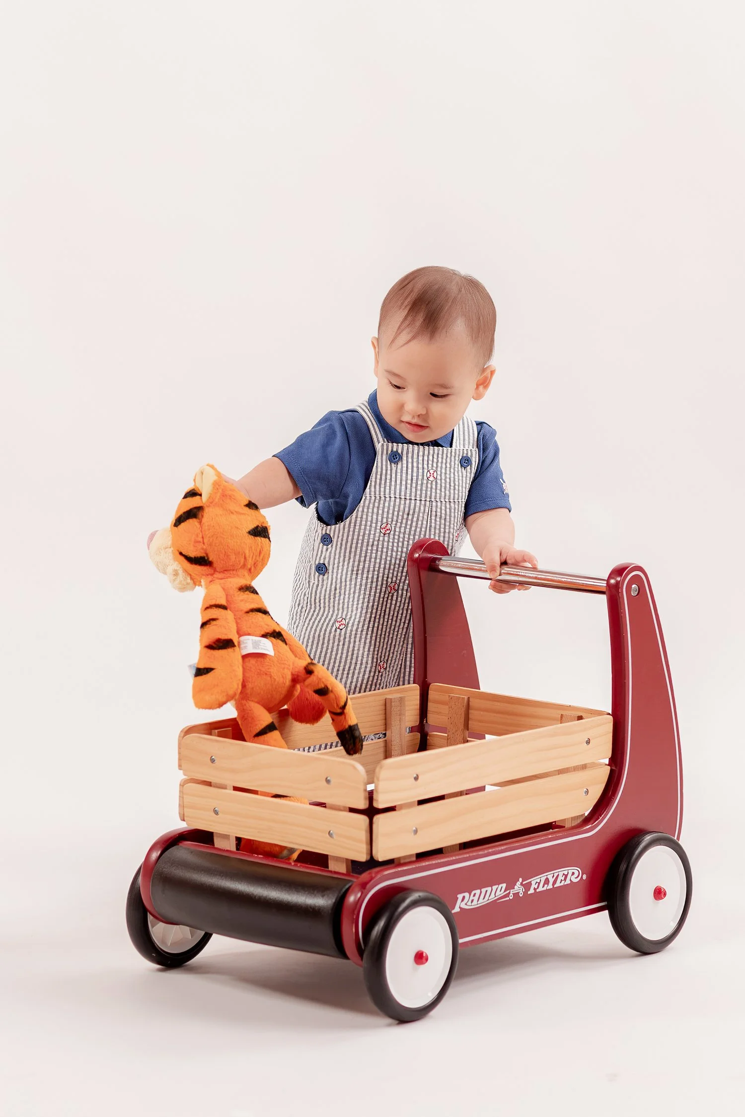 Winston holding Tigger over the wooden wagon