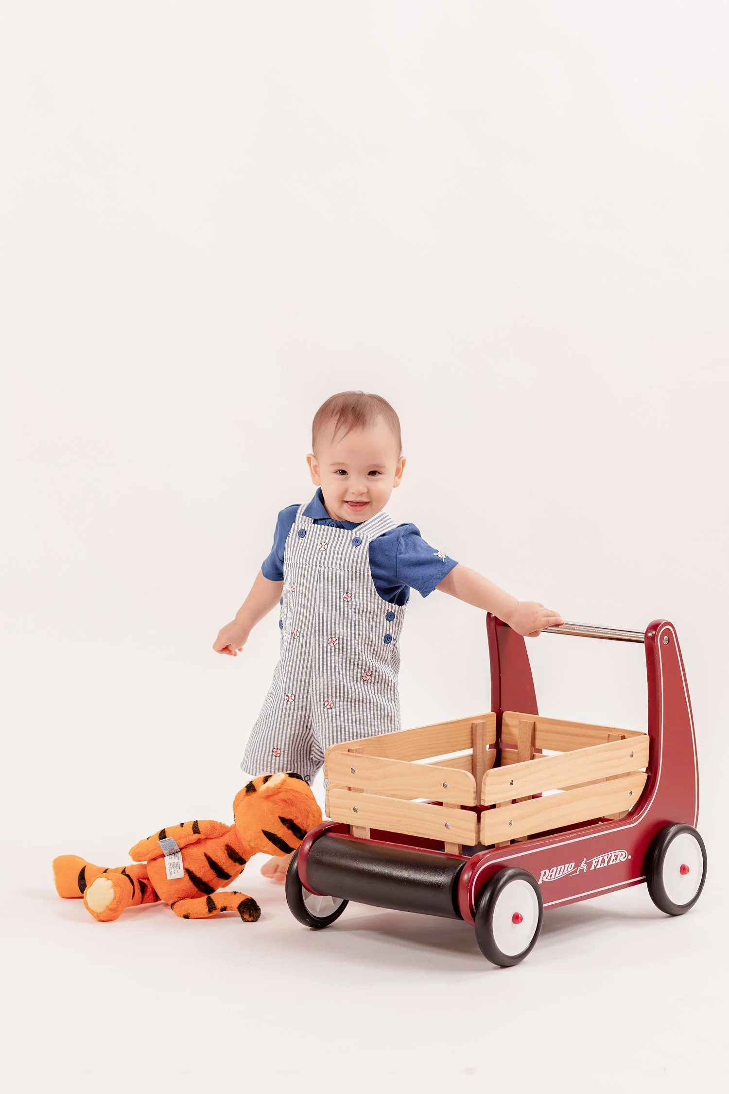 Winston smiling beside his wagon with Tigger on the floor