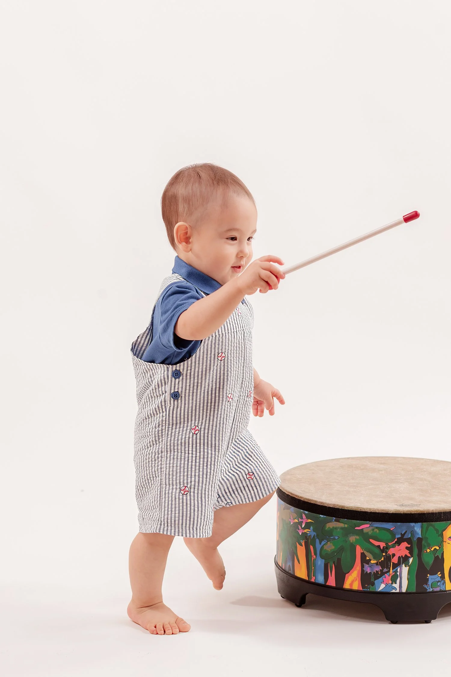 Winston holding a red-tipped drum mallet out in front of him