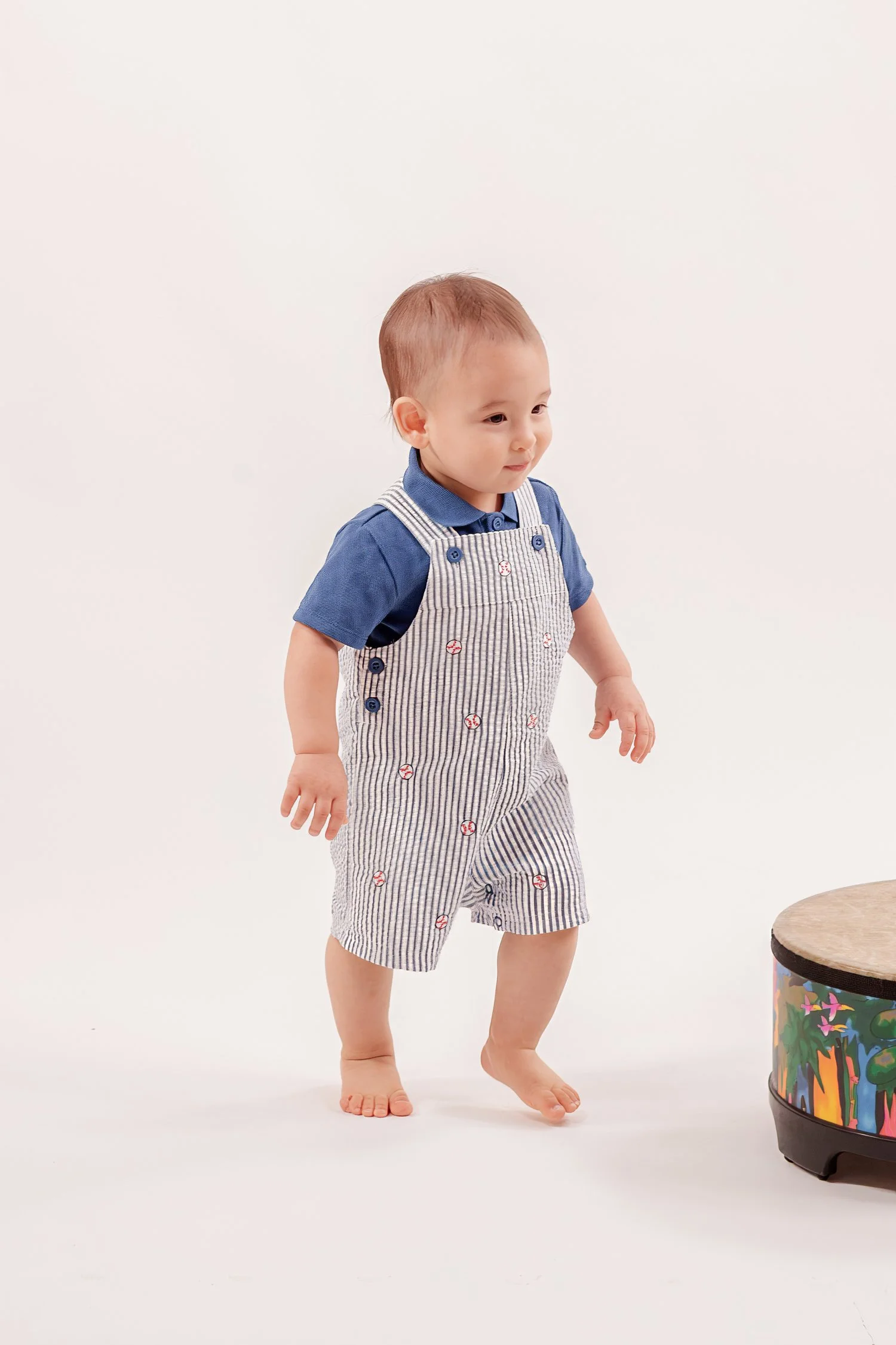 Winston standing barefoot on the white studio floor