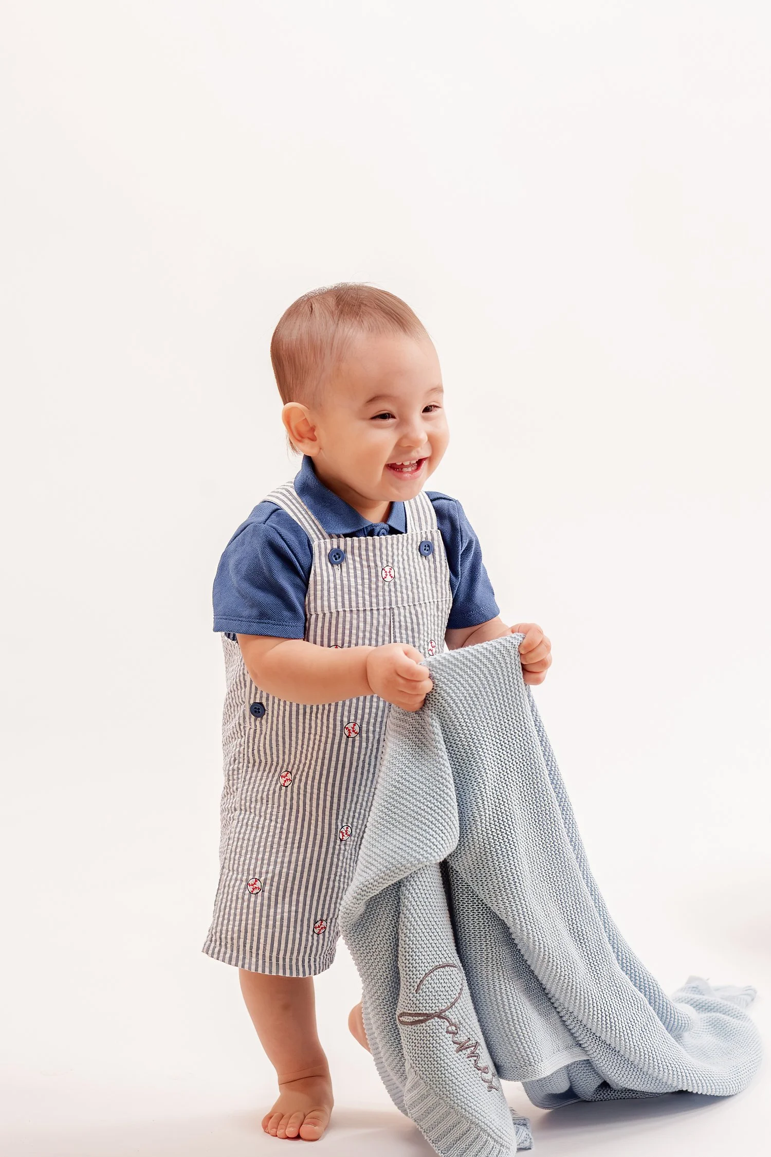 Winston smiling while holding his blue blanket