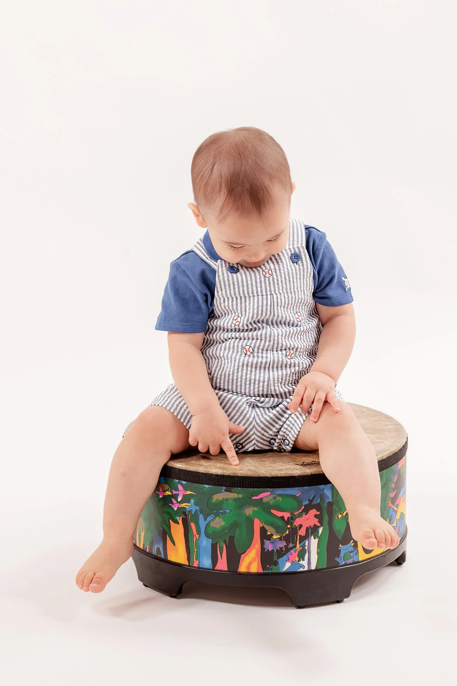 Winston looking down while sitting on his drum