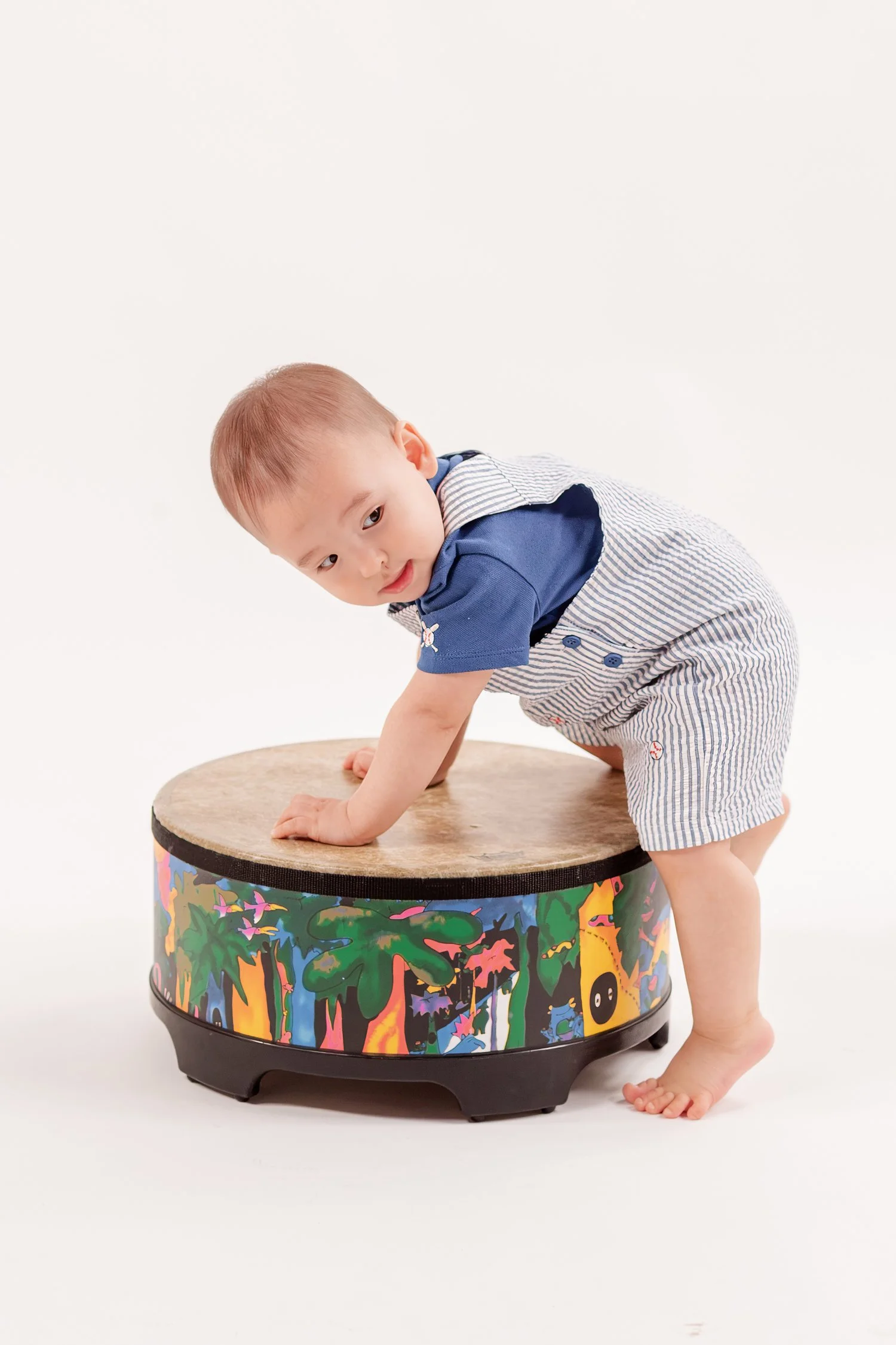 Winston leaning over the drum with both hands on top