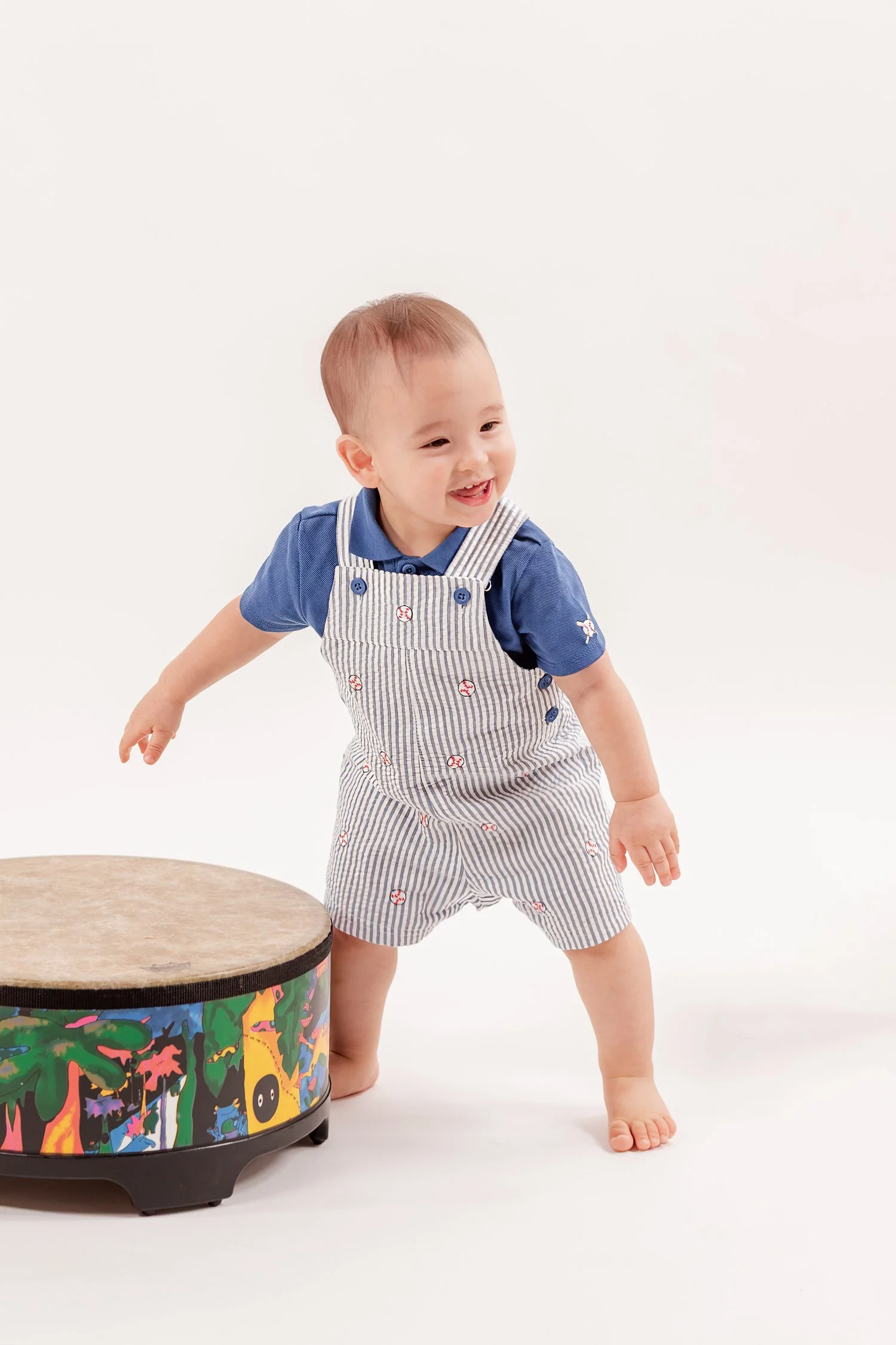 Winston smiling and standing beside his drum