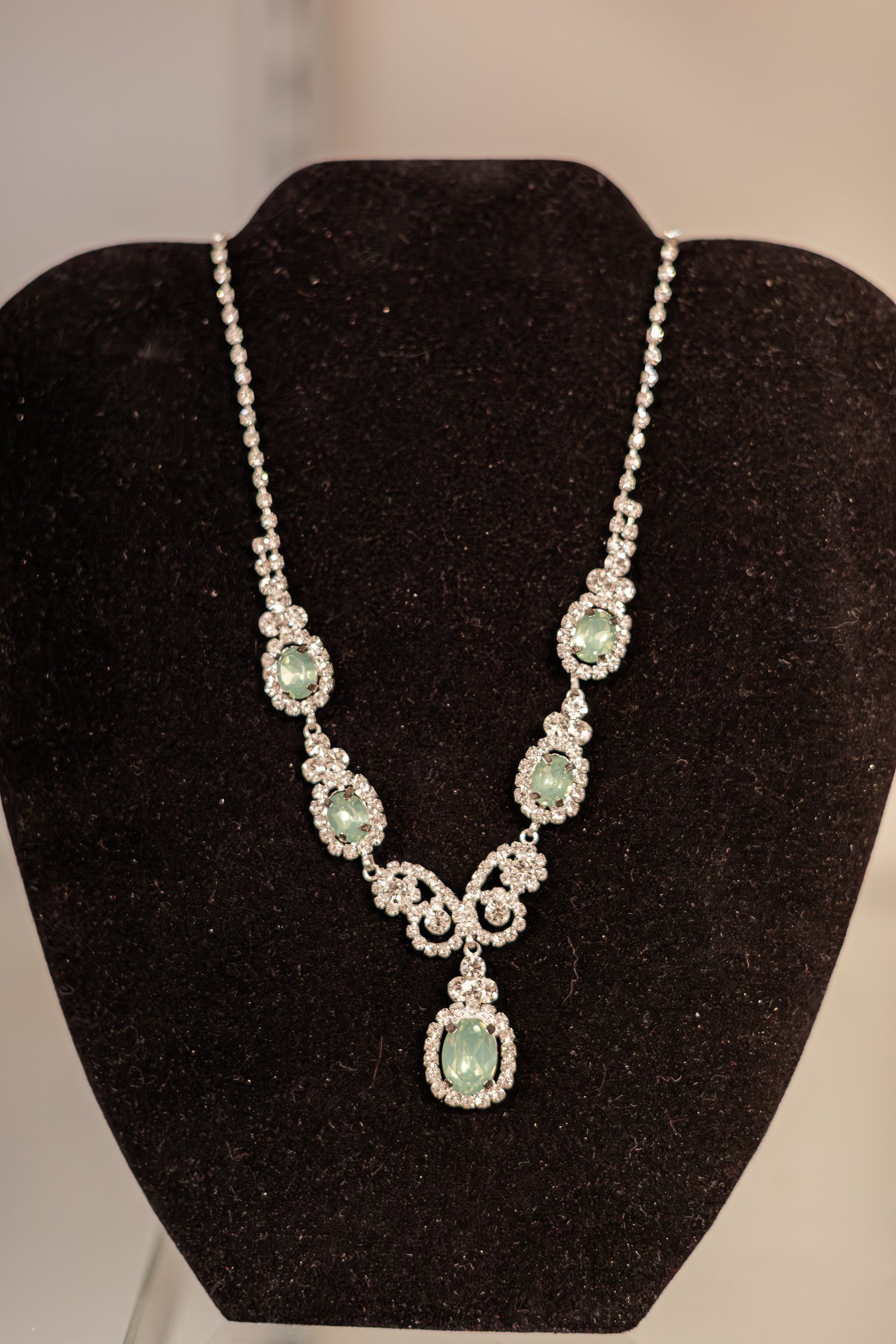 Mint green rhinestone necklace on a black velvet bust, brand photos for H&H New Creations Boutique in Bolivar MO