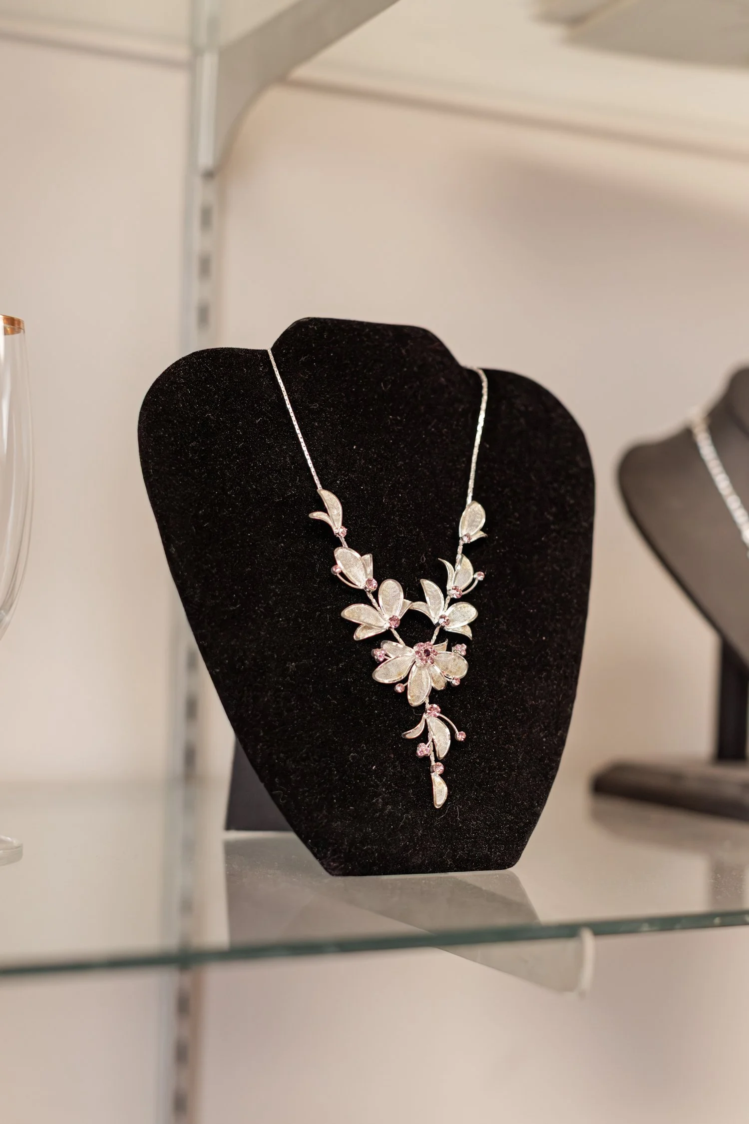 Silver leaf necklace with pink stones on a velvet bust, brand photos for H&H New Creations Boutique in Bolivar MO