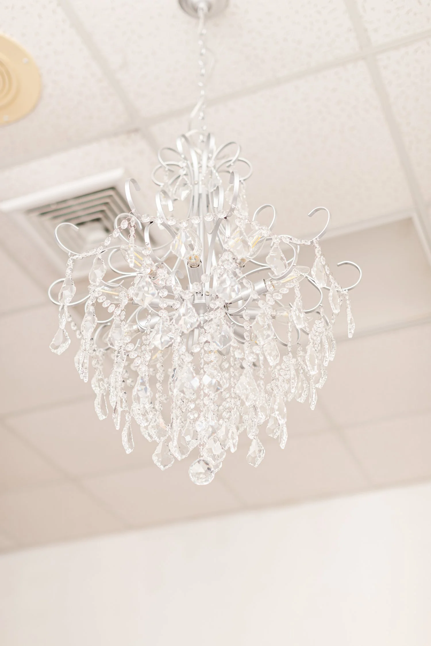 Crystal chandelier hanging over the boutique floor, brand photos for H&H New Creations Boutique in Bolivar MO