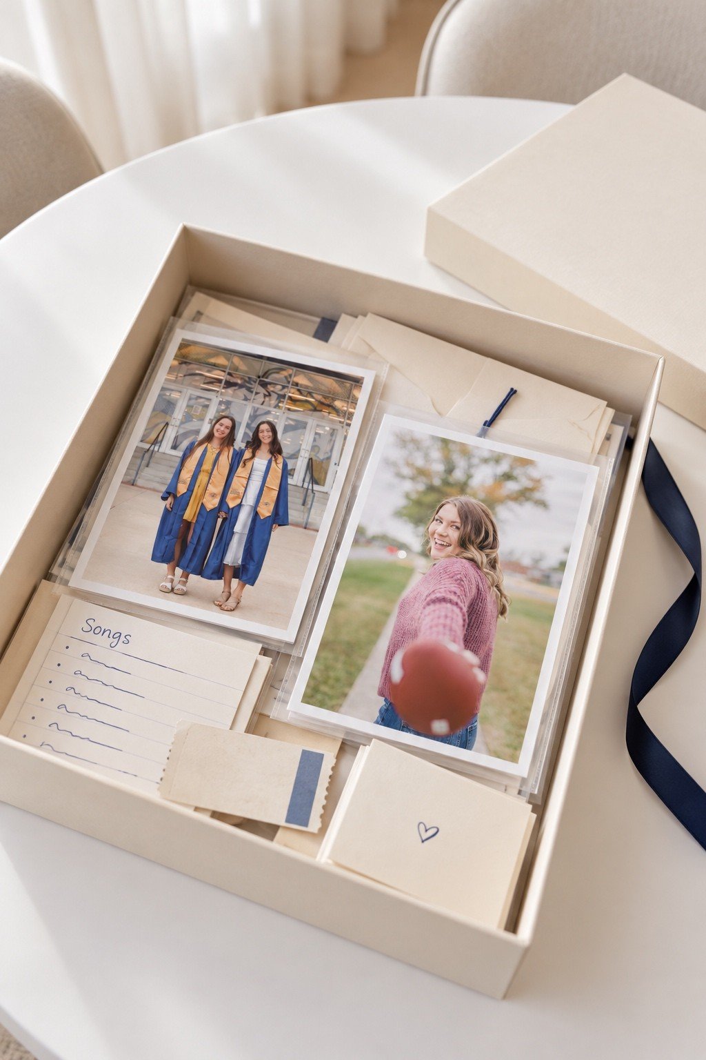 Senior photo prints in clear sleeves packed with notes inside a keepsake box.