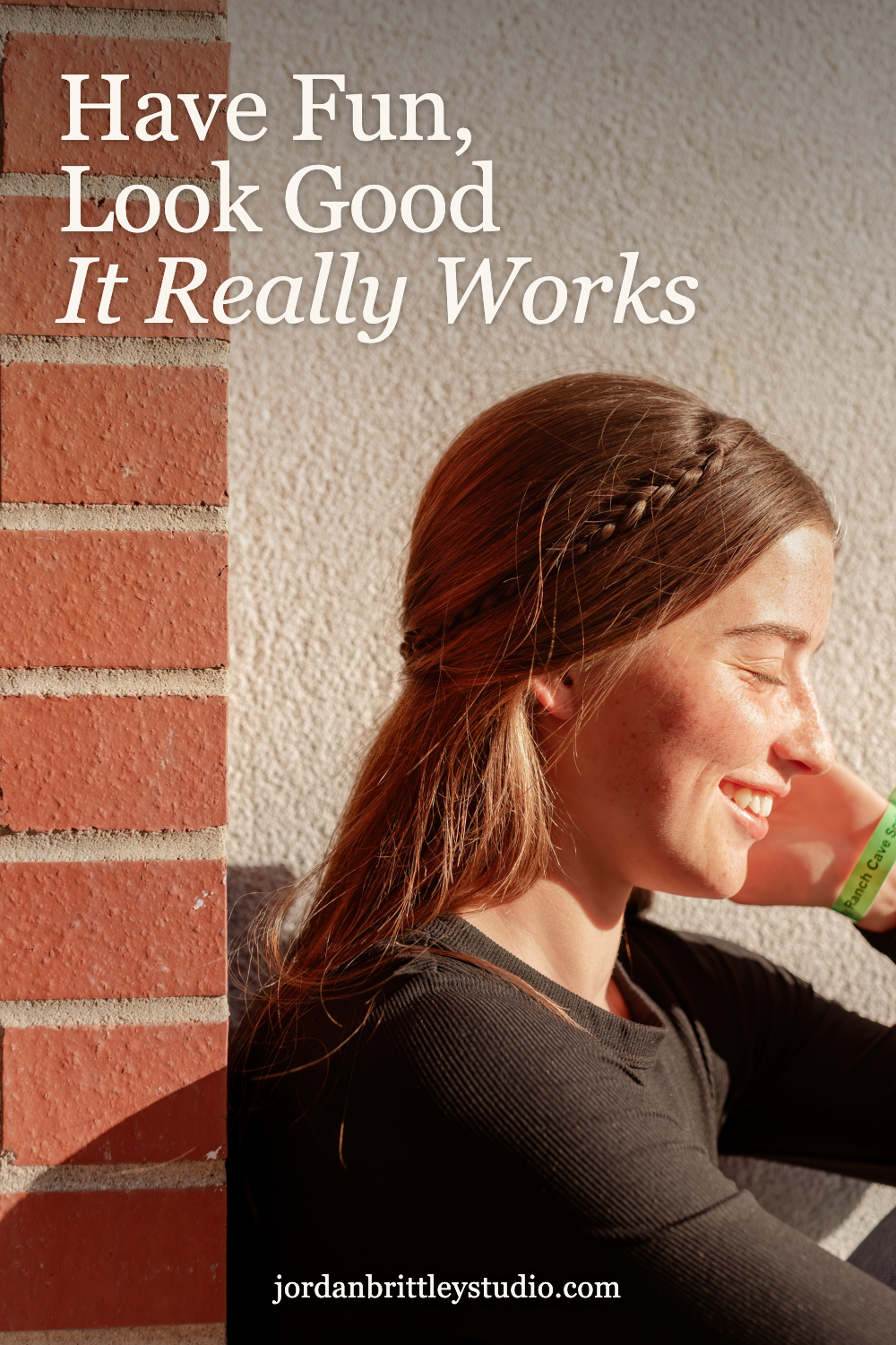 Senior smiling beside a brick wall on a graphic that reads Have Fun, Look Good. It Really Works.