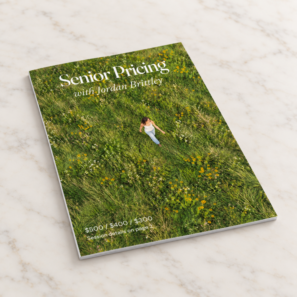 Senior Pricing with Jordan Brittley magazine viewed from an angle on pale marble.