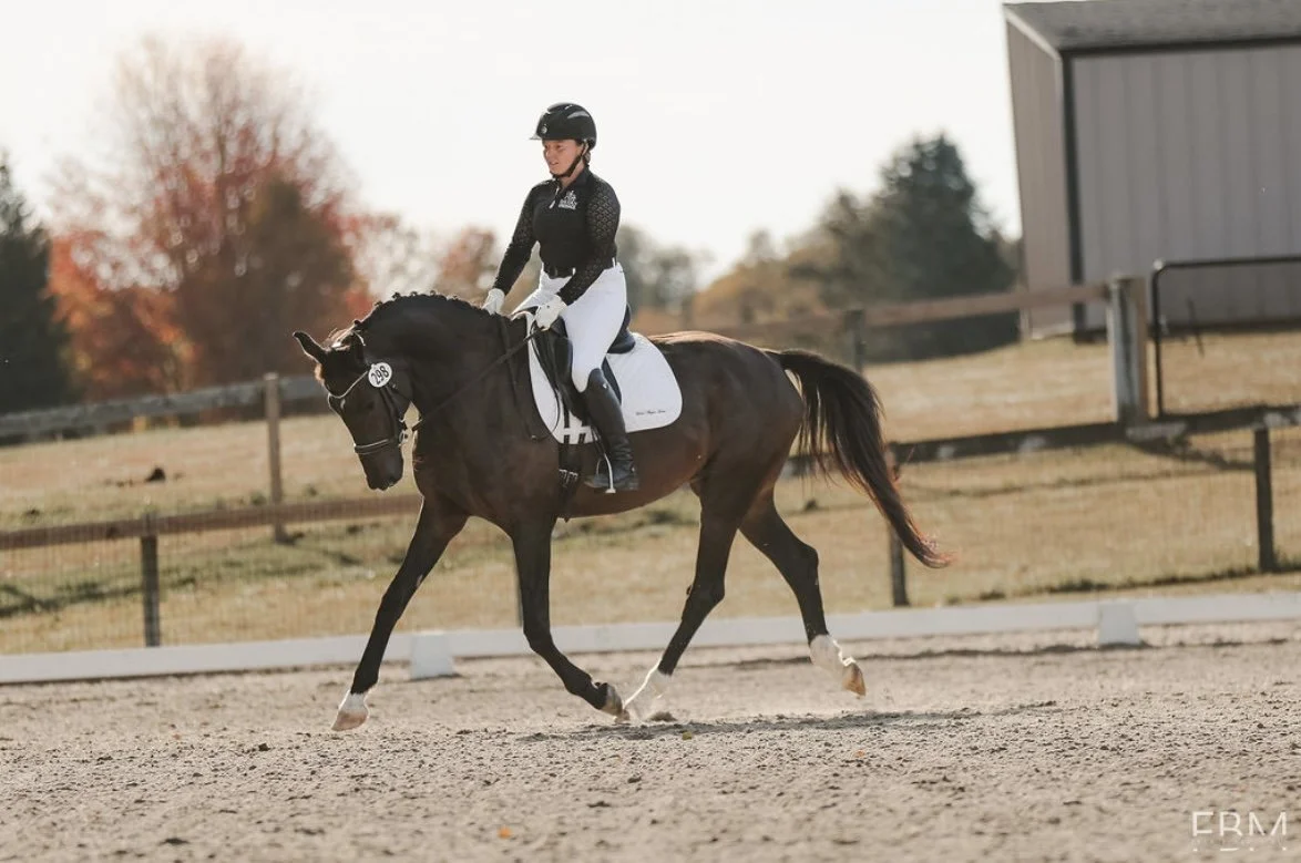 Professional horse trainer Emma Davern, owner of Davern Dressage competing at a dressage show
