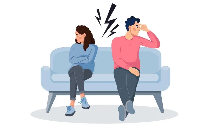 An illustration of a couple sitting back to back on a couch avoiding conflict, even though there is tension between them