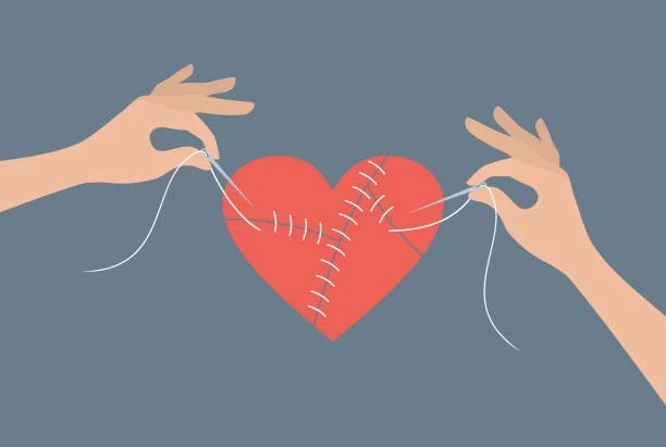 An illustration of two hands stitching together pieces of a heart that has been broken