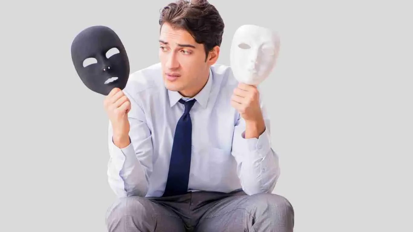 A man holds two masks before him illustrating two sides to his personality or persona with one being dark and one being light